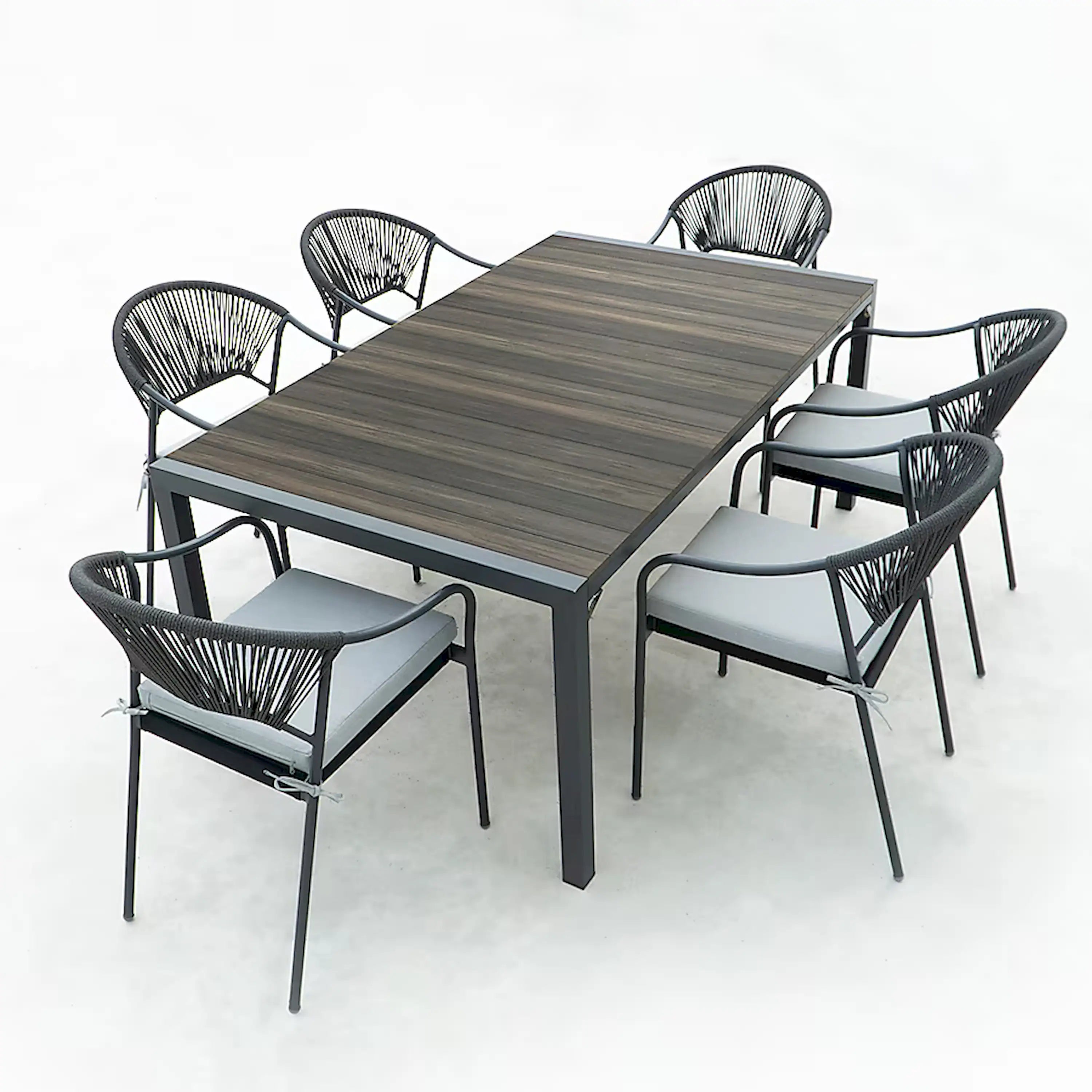 Outdoor patio dining set with rectangular table and six chairs, black rope backs.