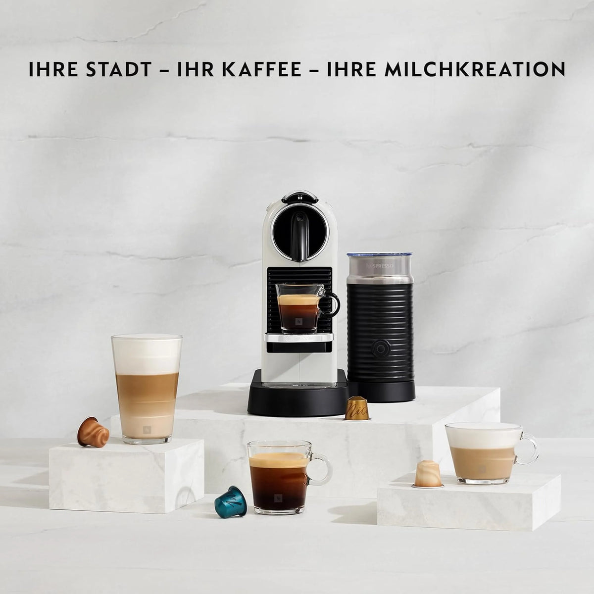 Black Nespresso Citiz espresso machine with frothing container and two cups on stand