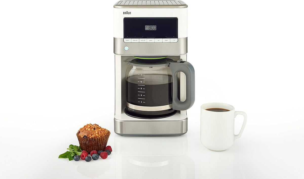 Compact view of stainless steel and white 12-cup drip coffee maker with glass carafe and mug