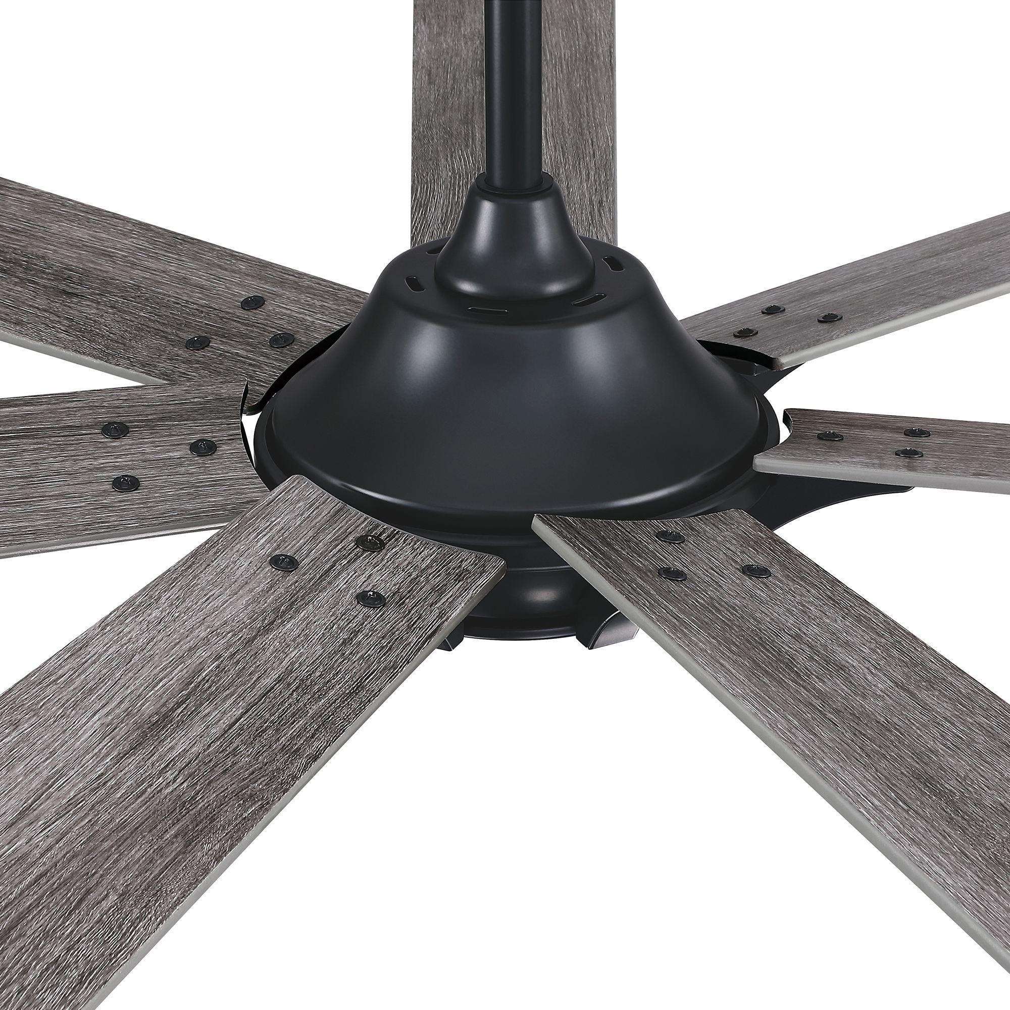 Close-up of black ceiling fan motor with gray reversible blades