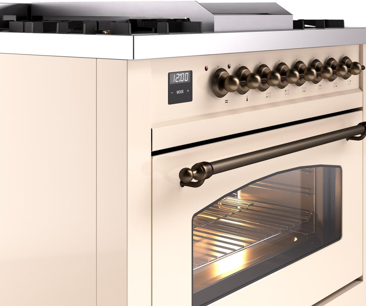 Antique white freestanding dual fuel range side view with bronze knobs and oven door window