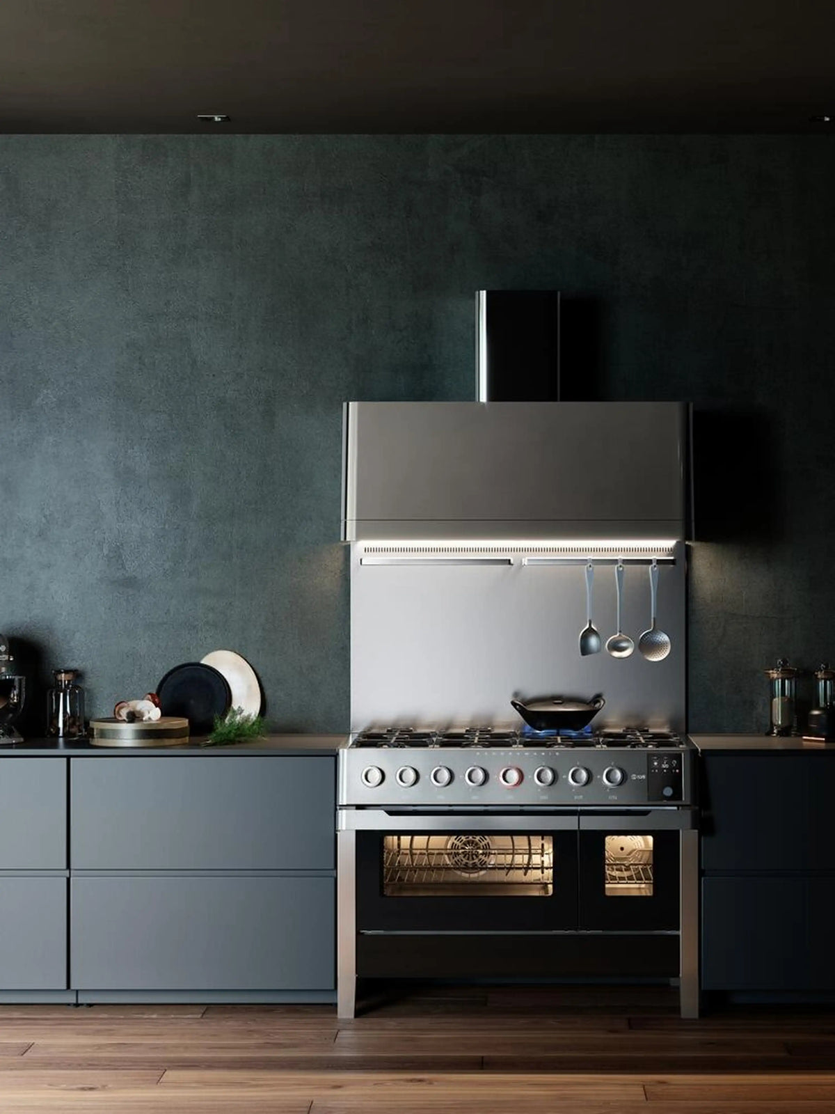 Stainless steel freestanding dual fuel range in a kitchen with oven window and burner controls