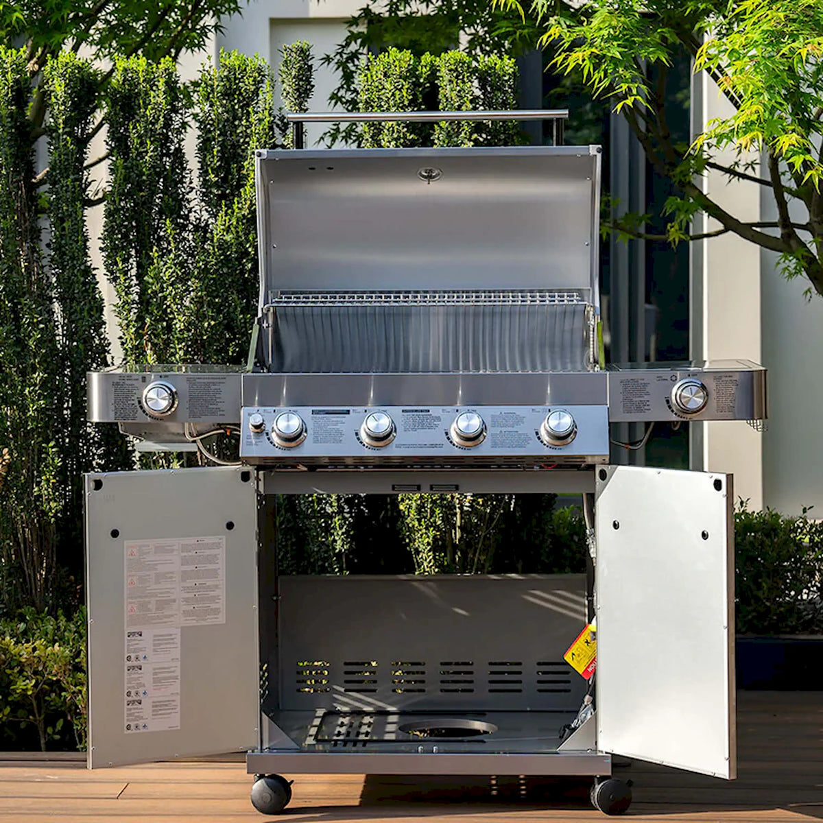 Stainless steel propane grill with lid open showing interior cooking area and controls