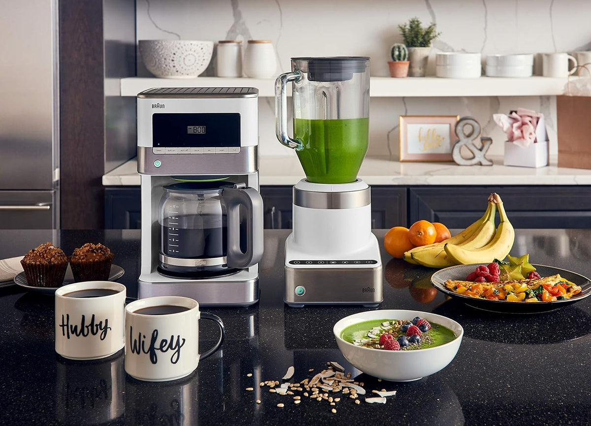 Stainless steel and white 12-cup drip coffee maker on kitchen counter with carafe in view