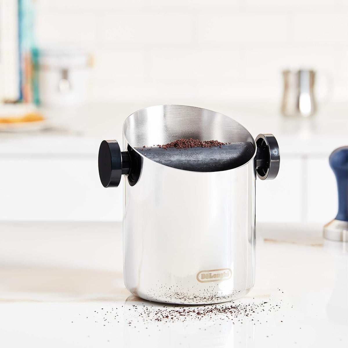 Coffee knock-out box with domed lid holding coffee grounds and black side handles