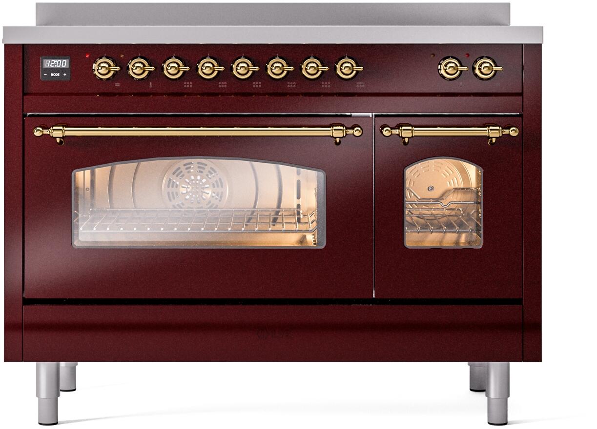 Freestanding electric induction range in burgundy with brass-trimmed front controls and windows
