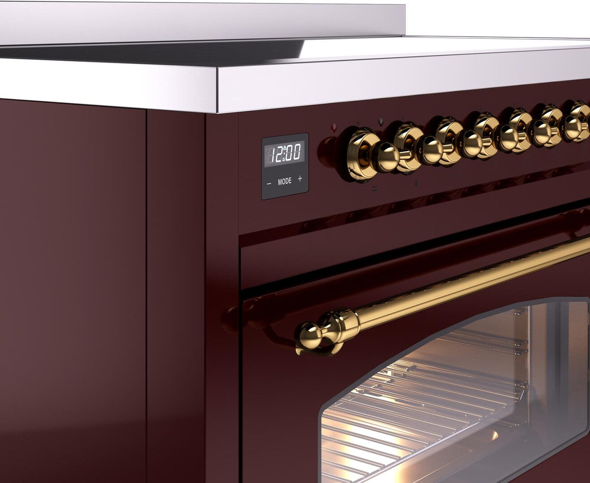 Brass knob control panel and digital display on burgundy electric induction range