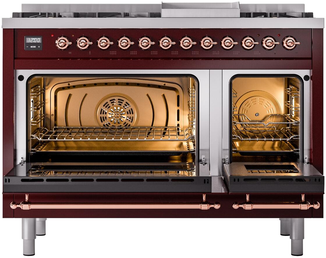 Burgundy dual-fuel range with both ovens open, illuminated interior, and copper trim
