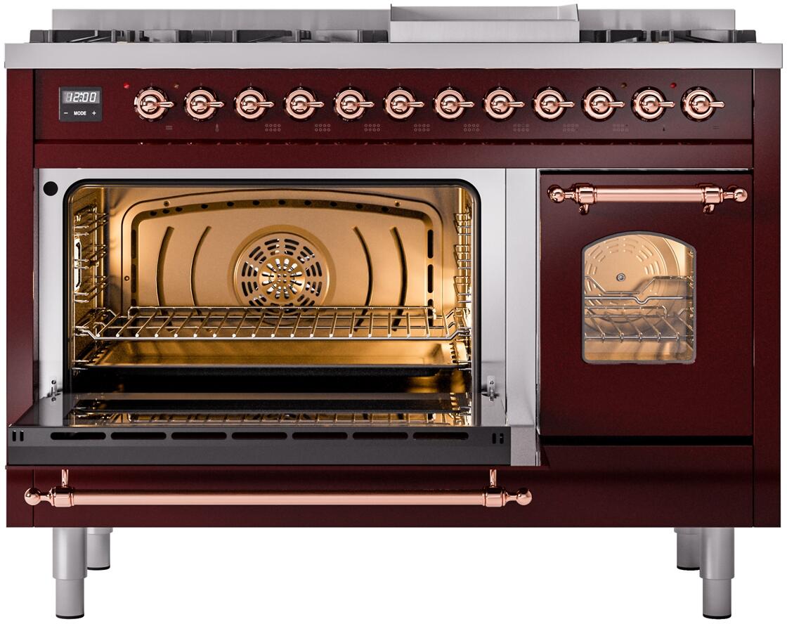 Burgundy dual-fuel range ovens open showing racks and warm interior lighting with copper accents