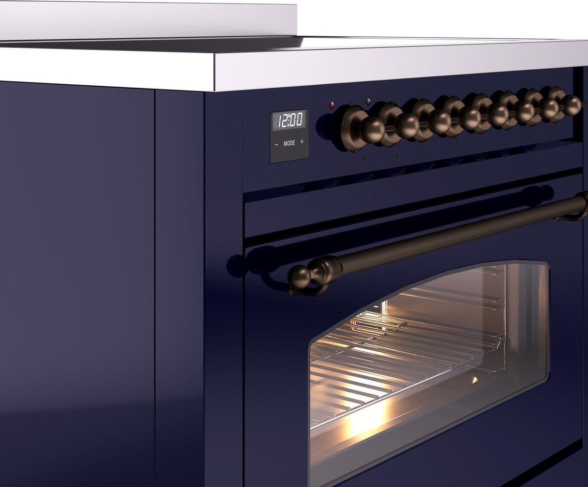 Midnight blue range control panel with bronze knobs and oven door with window