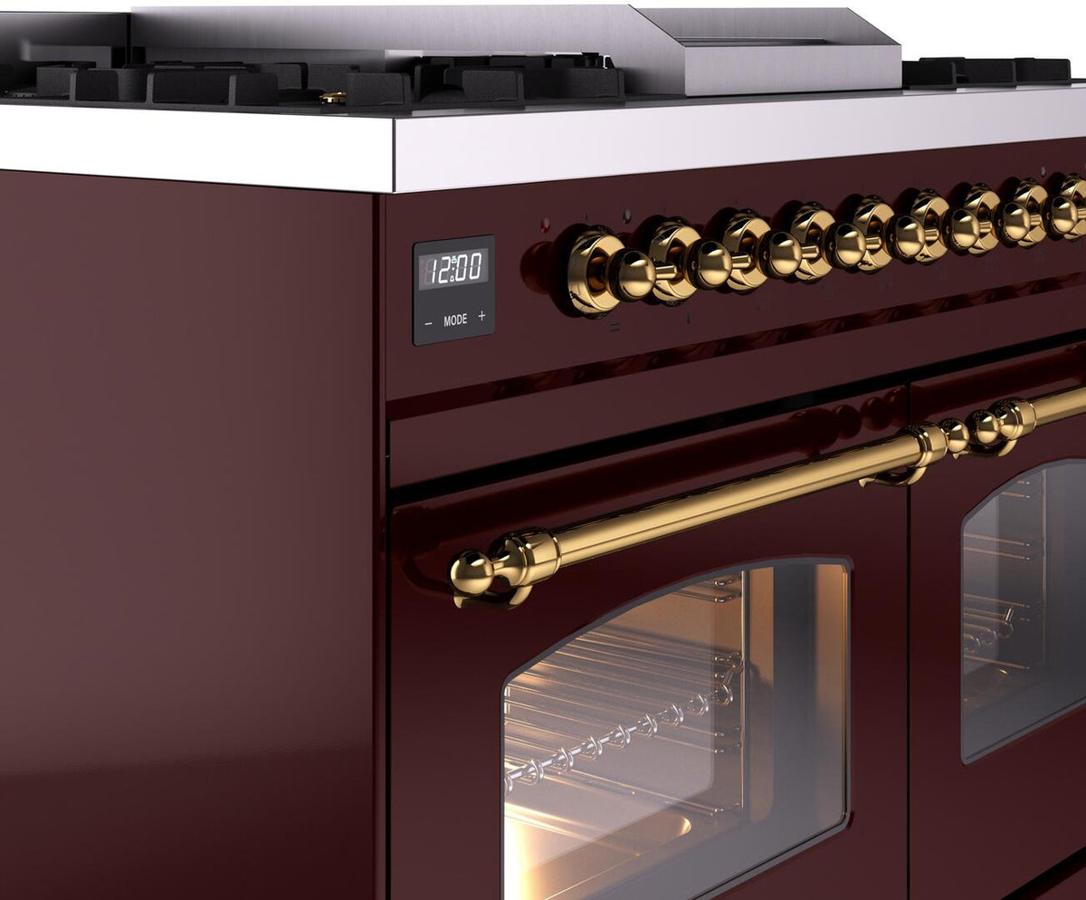 Burgundy range controls and brass handle with lit oven window