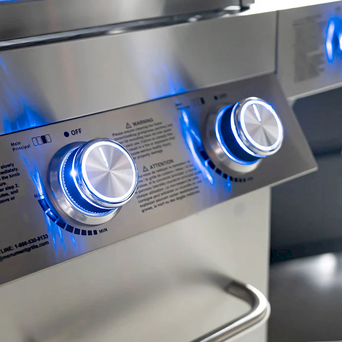 Stainless grill control knobs with blue illuminated settings