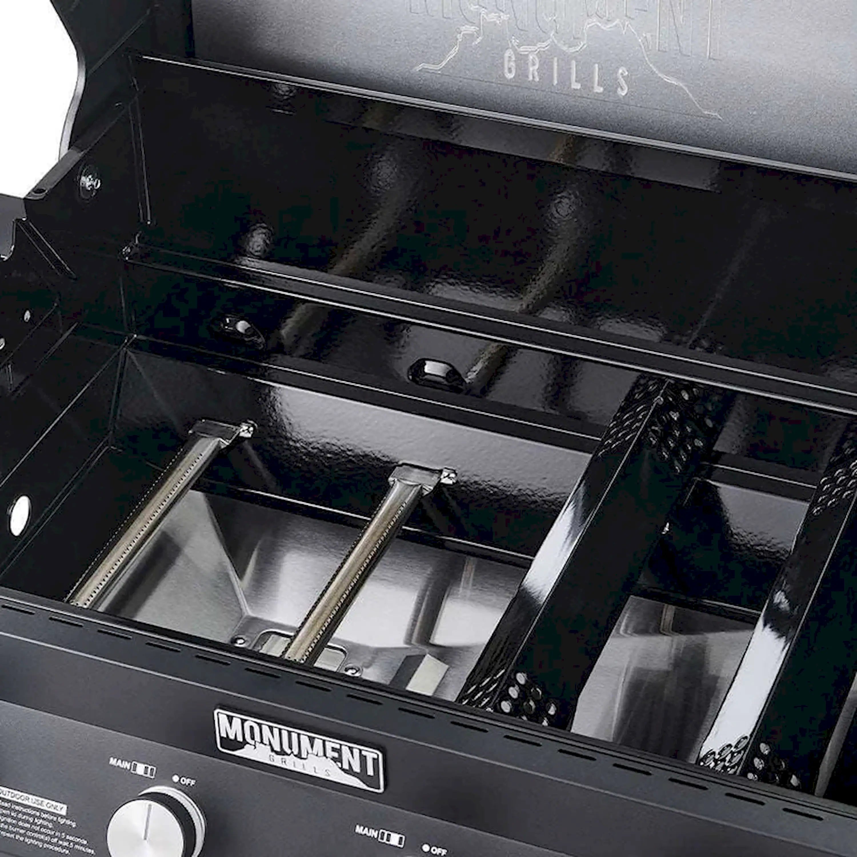 Black grill interior with stainless burner box and metal heat shield