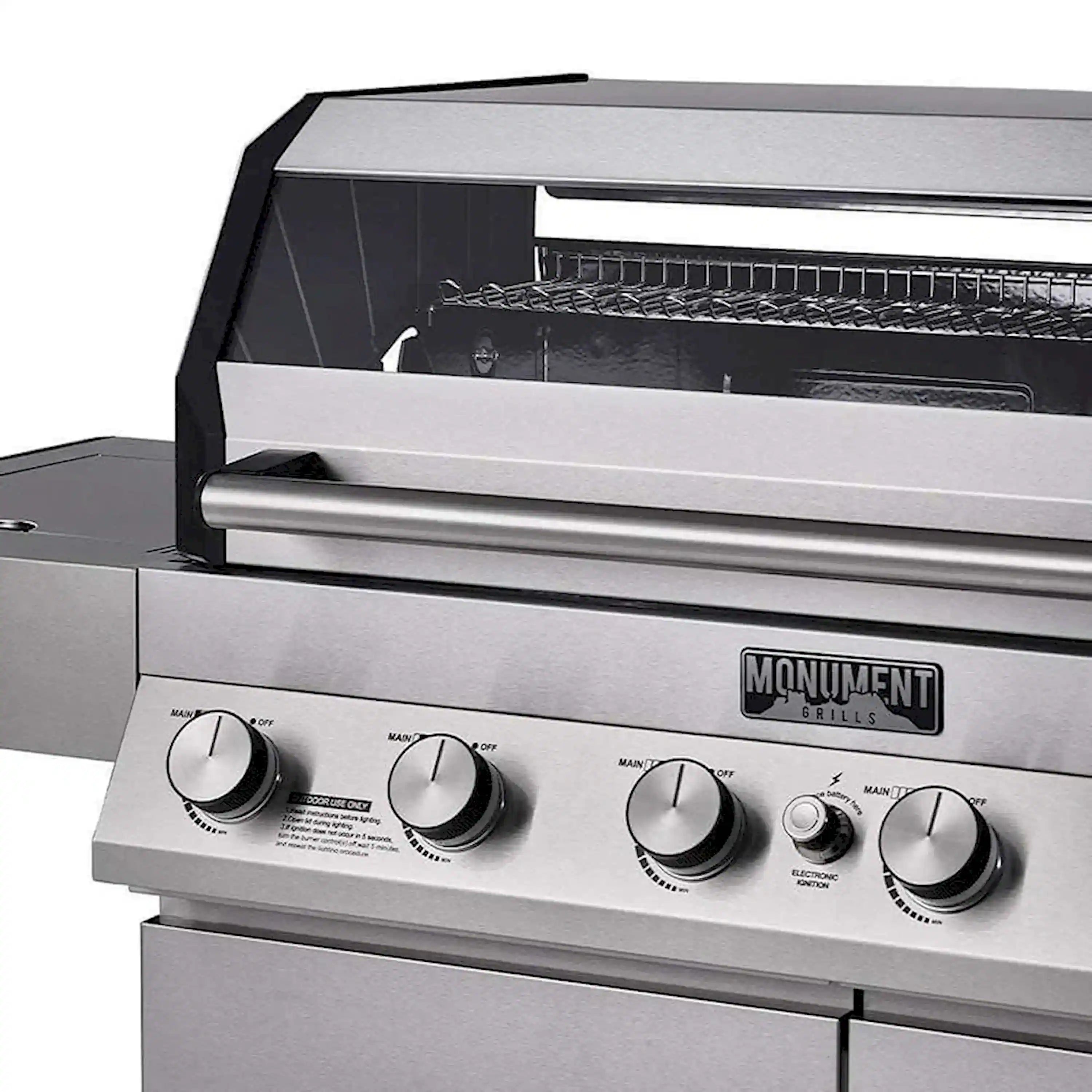 Stainless gas grill with control knobs and closed hood