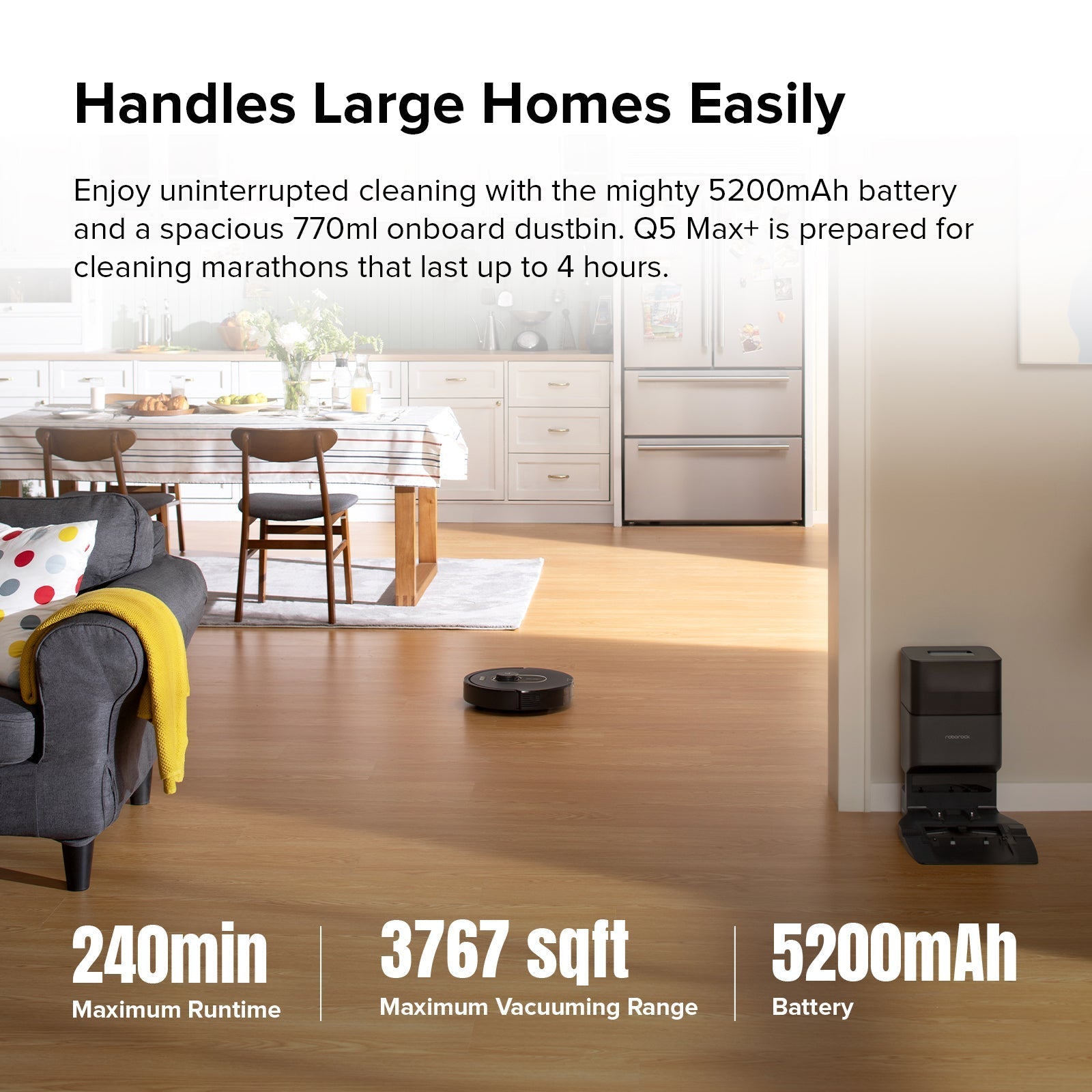 Robot vacuum on hardwood floor near kitchen entry, with dock in background