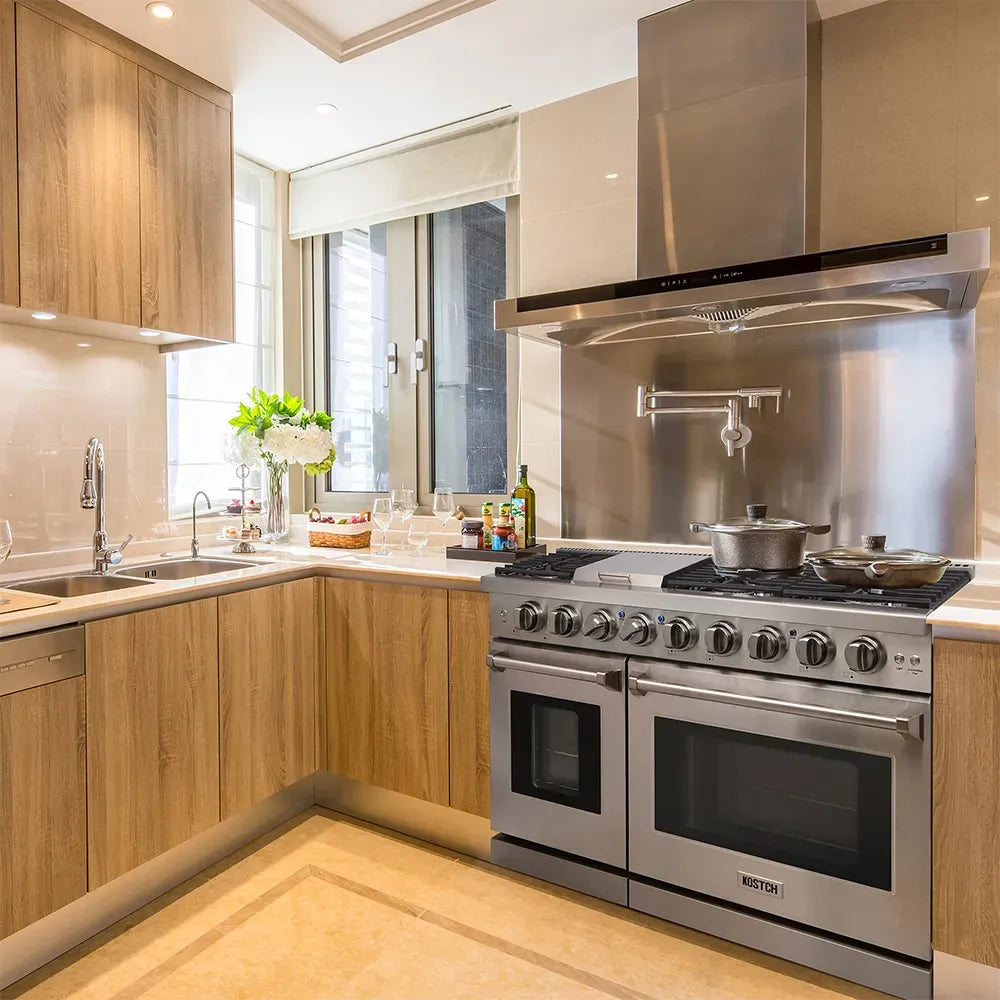 Stainless gas range with six burners and two oven doors in a modern kitchen