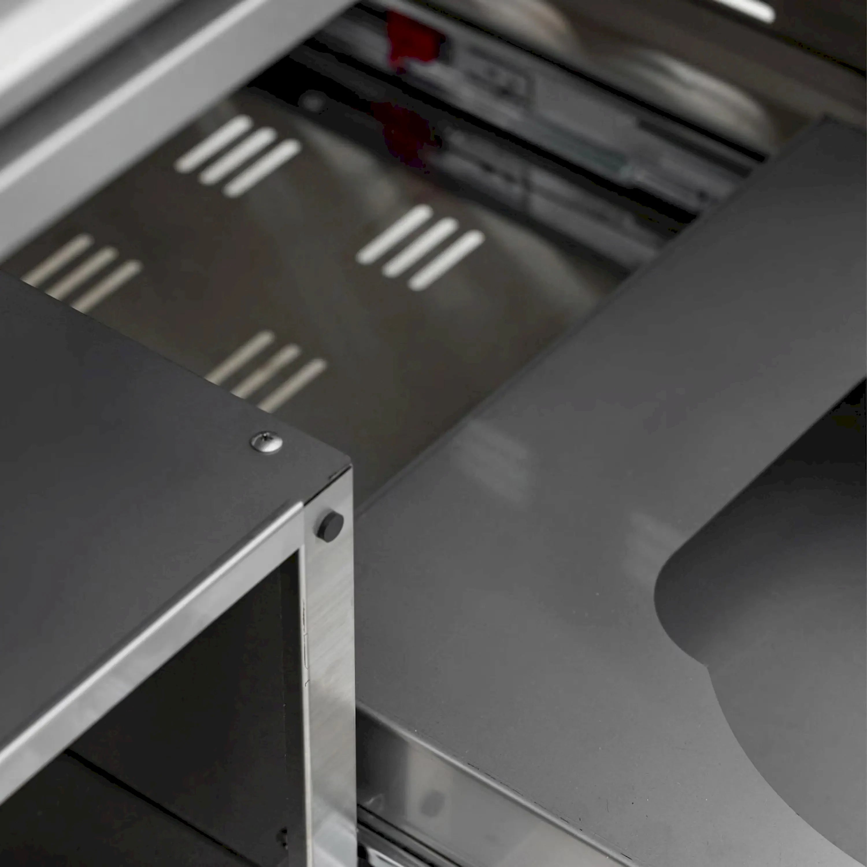 Stainless steel grill interior with vent slots and control area