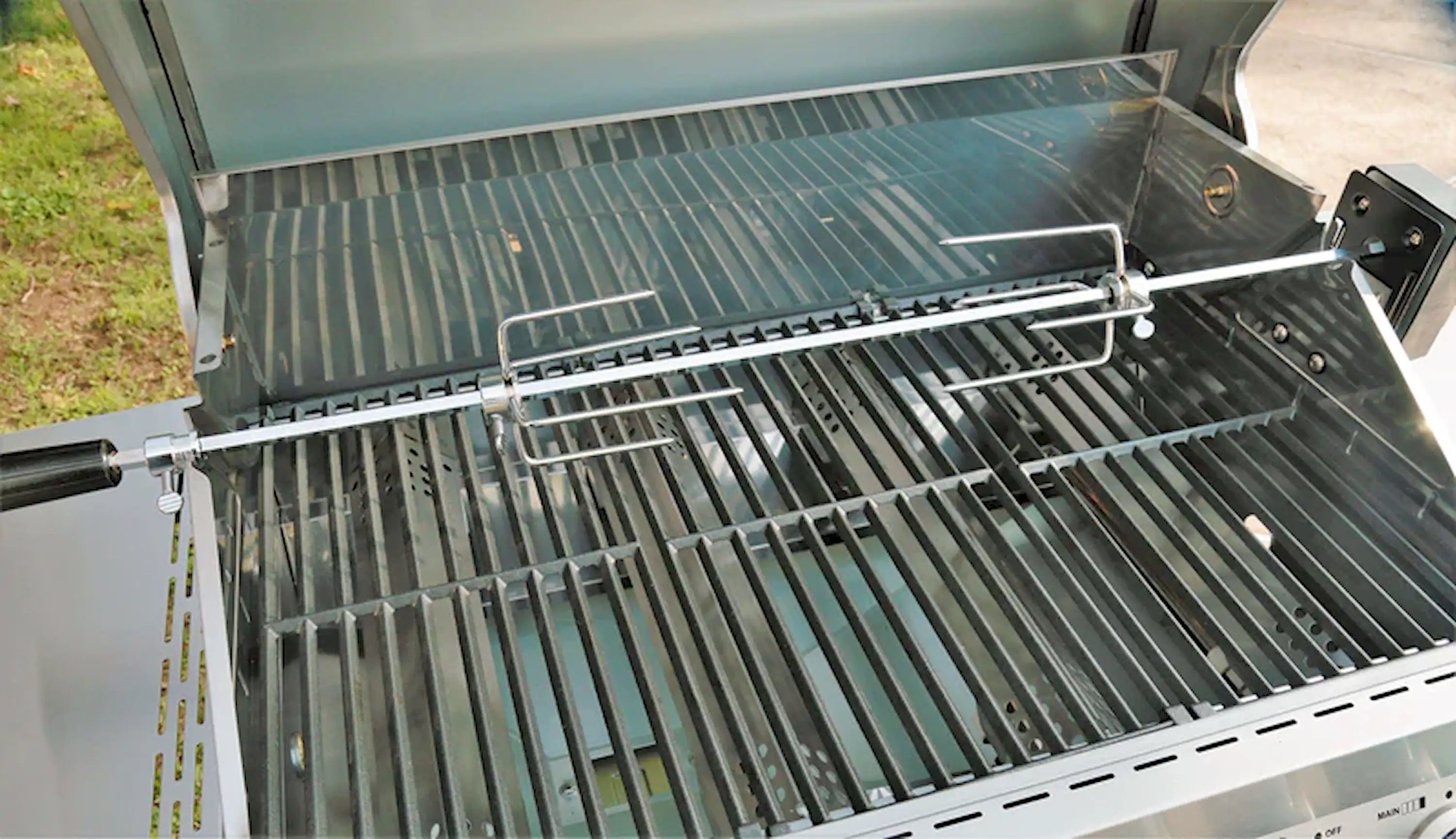 Rotisserie grill mount with wire frame above open grill grates