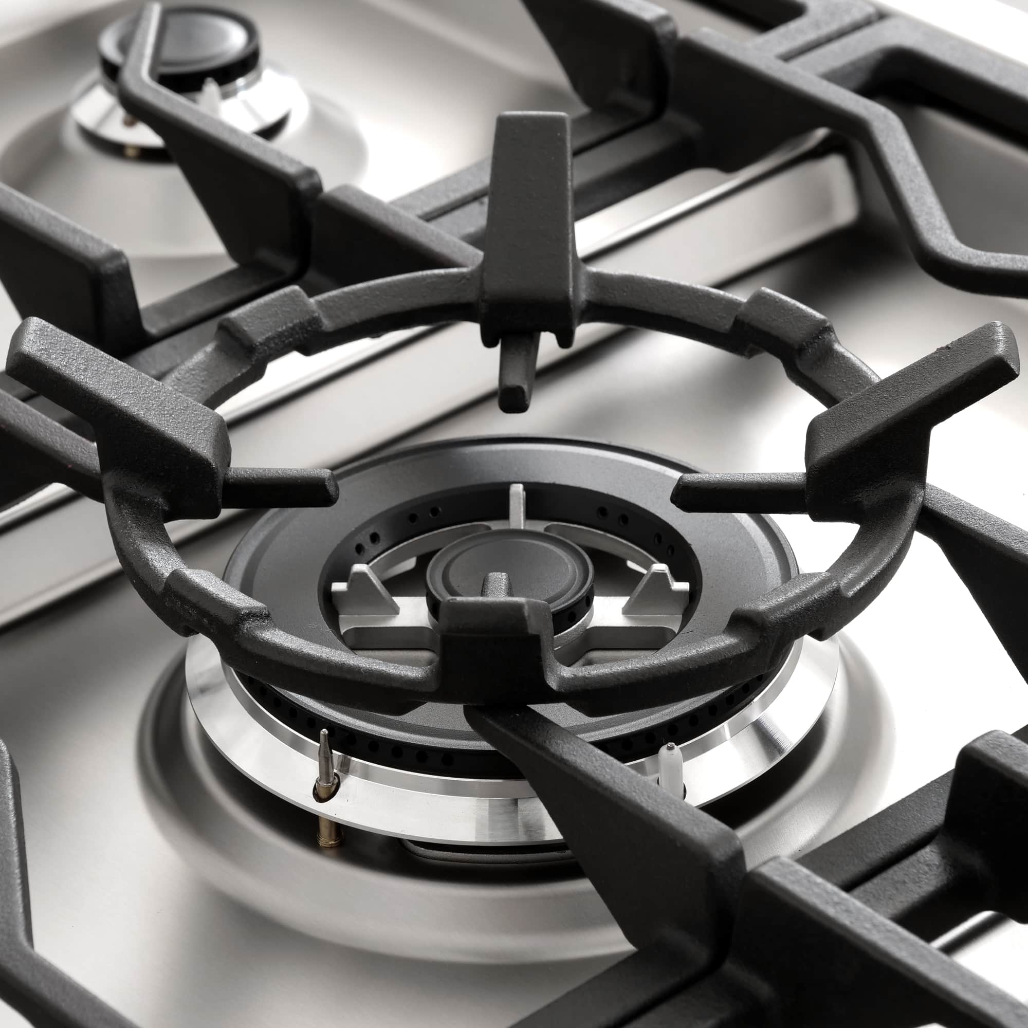 Stainless steel gas range burner with black grate and round burner head