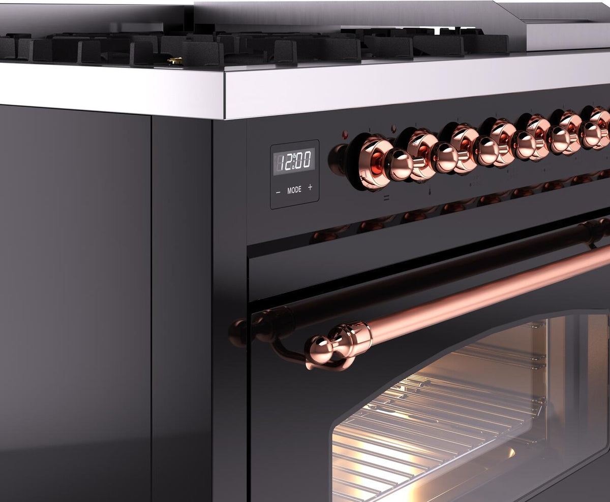 Dual fuel range front with copper control knobs, digital clock, and lit oven door