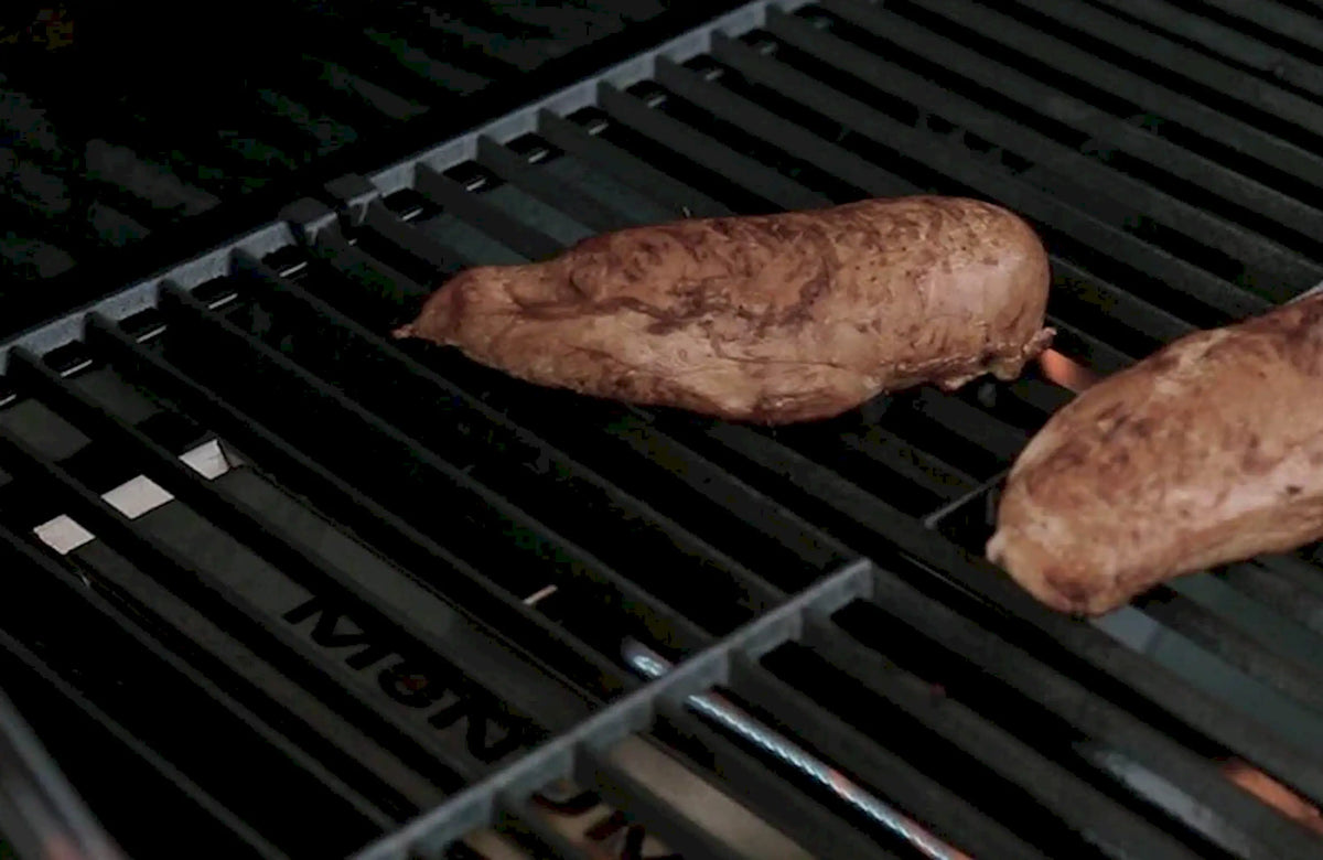 Smoking wood chunks in a Monument smoker box on grill grates