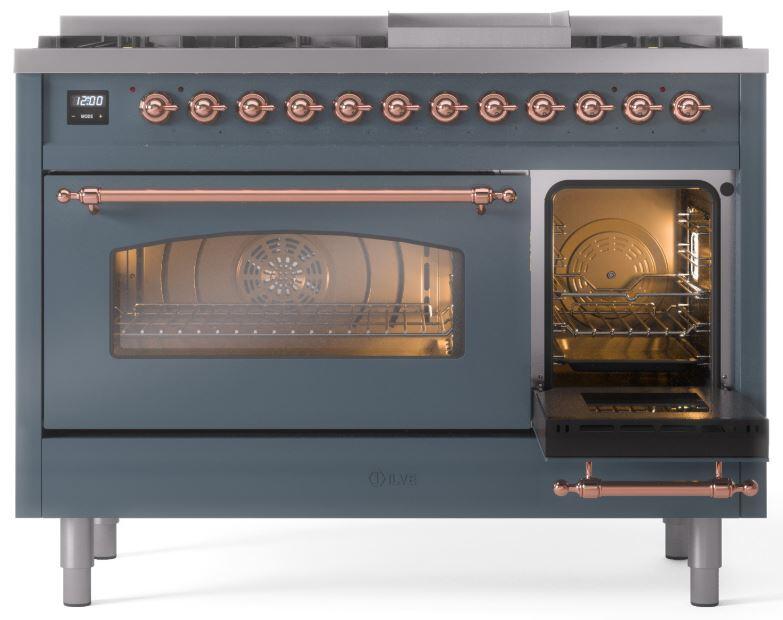 Freestanding dual-fuel range with blue-grey doors and lit oven; copper trim accents