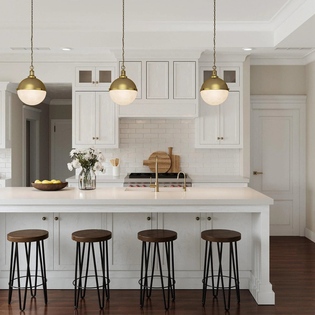 Gold globe island pendant lights with frosted glass shades suspended by chains