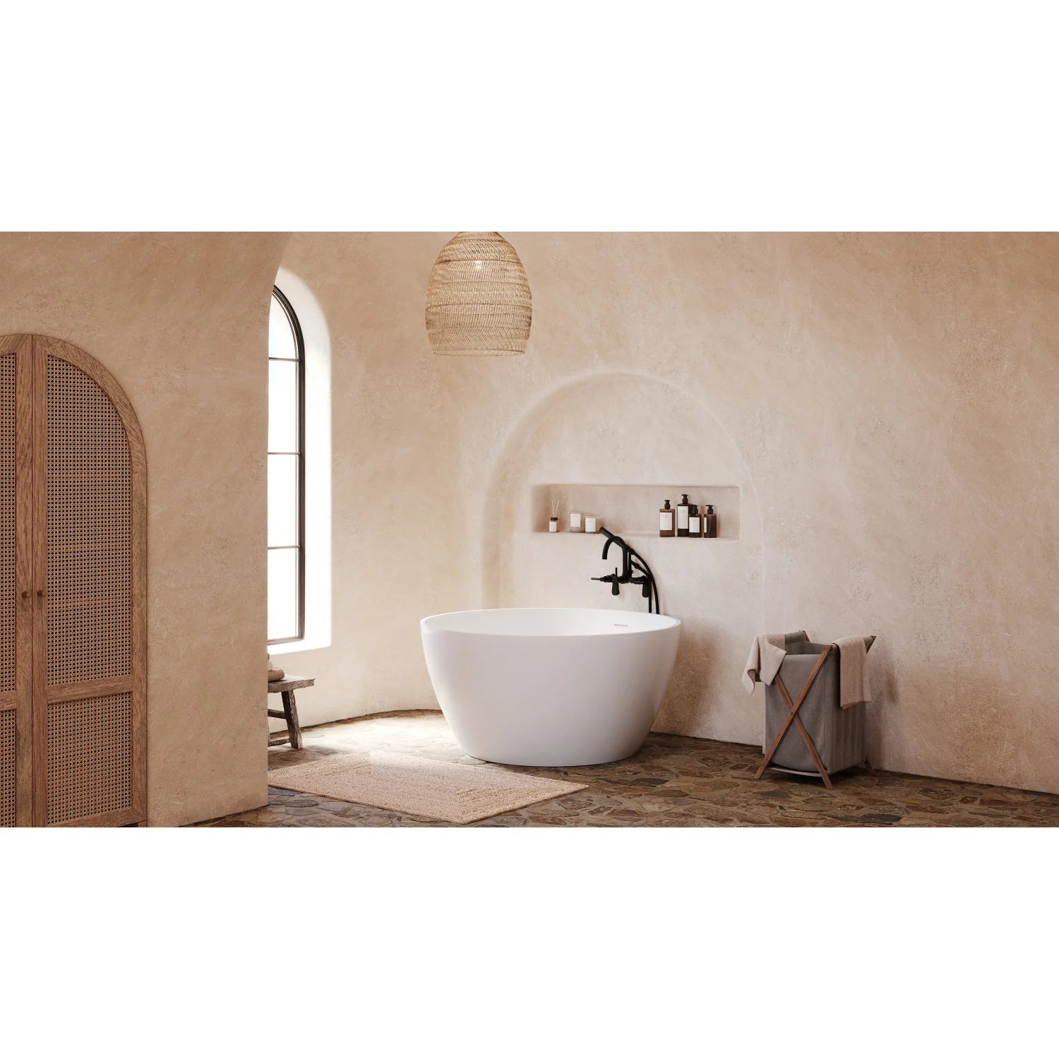 Wall-mounted matte black tub faucet with showerhead over white freestanding tub