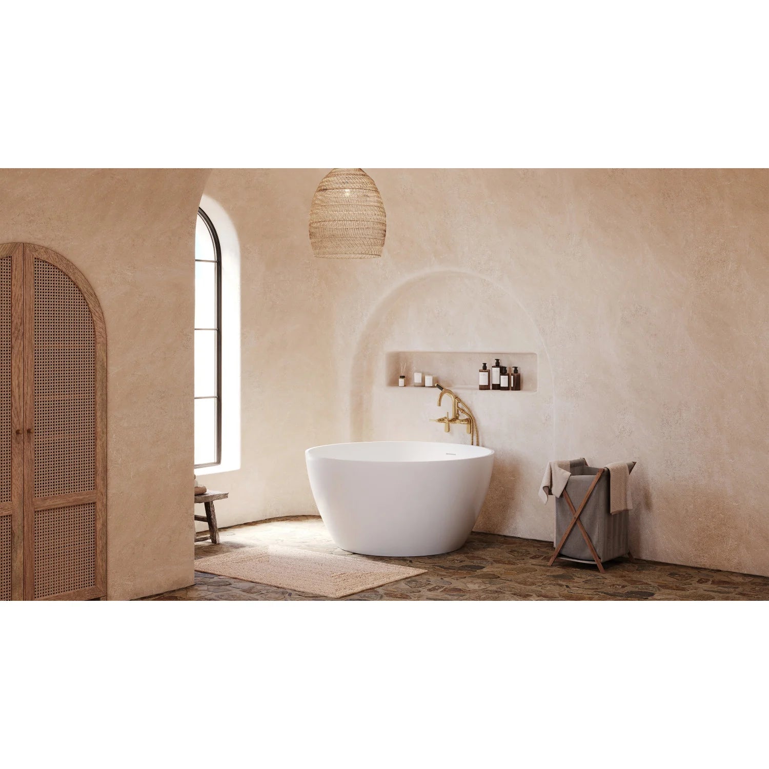 Brushed brass tub faucet with handshower over white freestanding tub