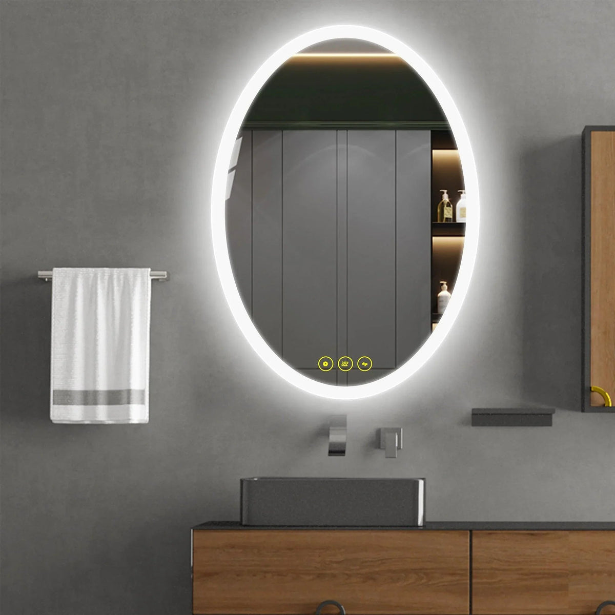 Oval LED bathroom vanity mirror with glowing ring, mounted above a sink and faucet
