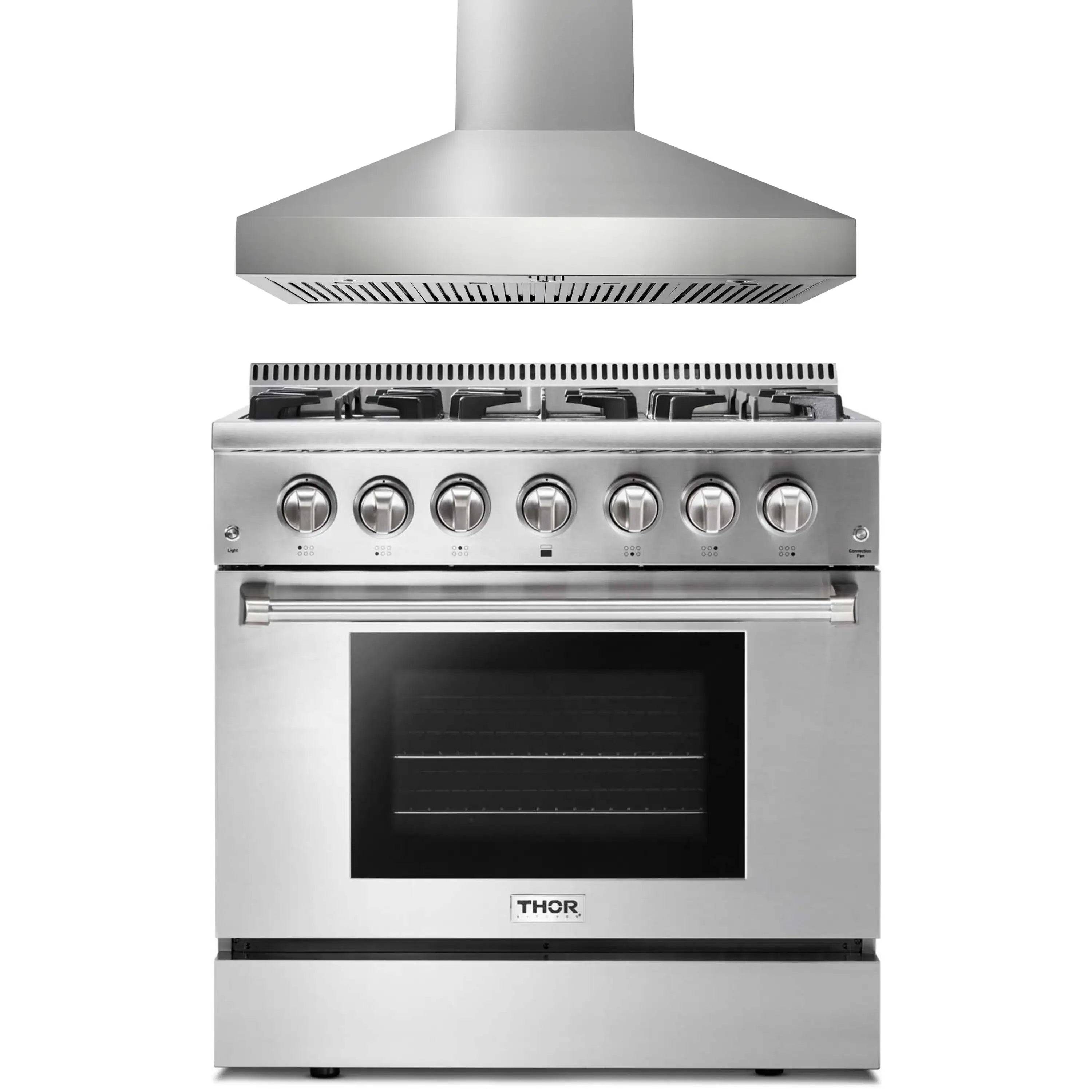 Stainless steel dual fuel range with wall-mounted hood, control knobs and oven door