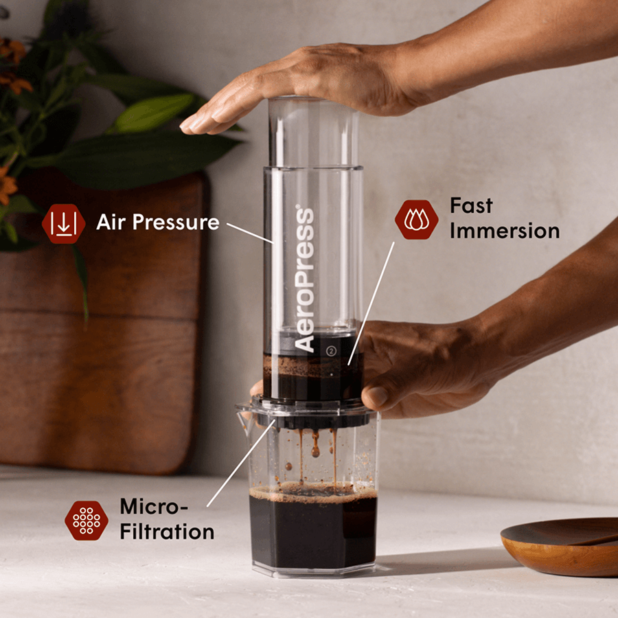 Clear XL coffee maker brewing dark coffee in a transparent chamber