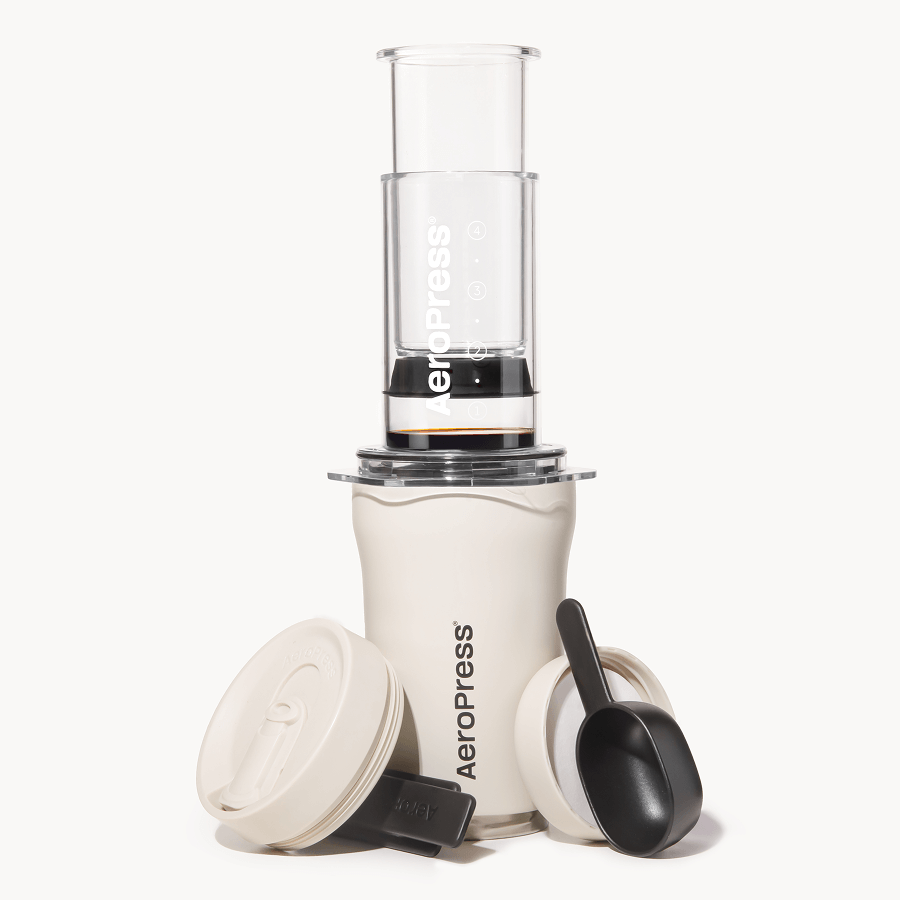 Cream 3-in-1 AeroPress-style coffee maker with travel tumbler, scoop, and filter holder
