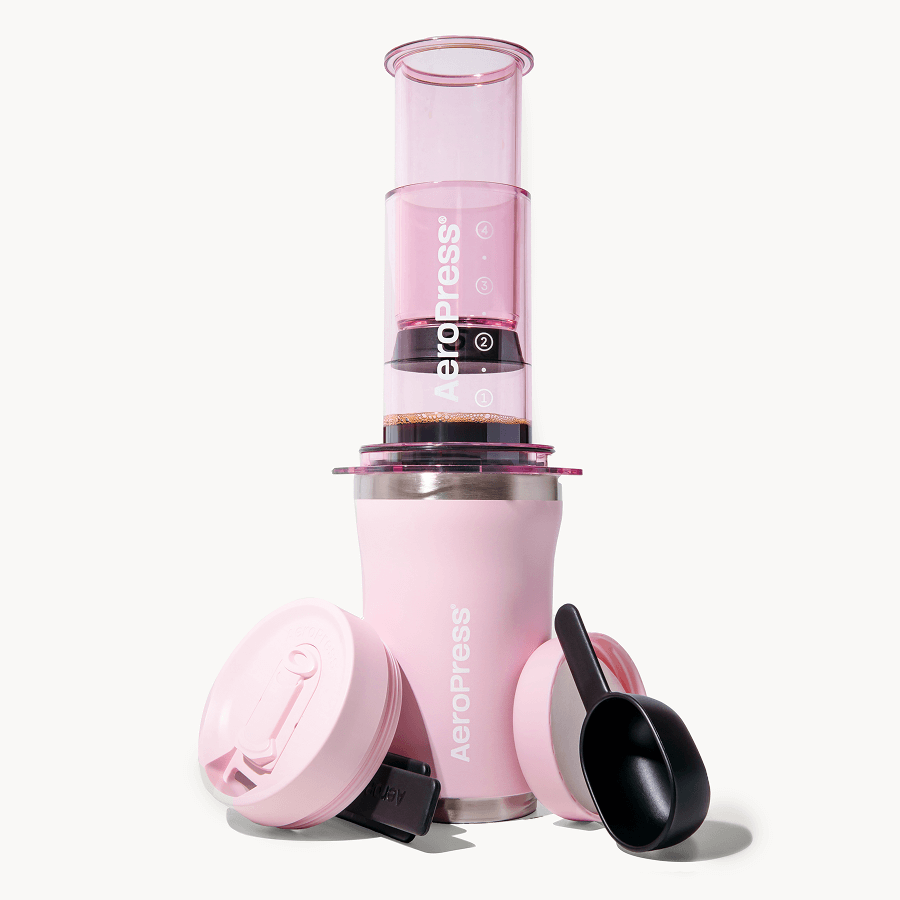 Pink AeroPress Go Plus coffee maker with press cylinder and base