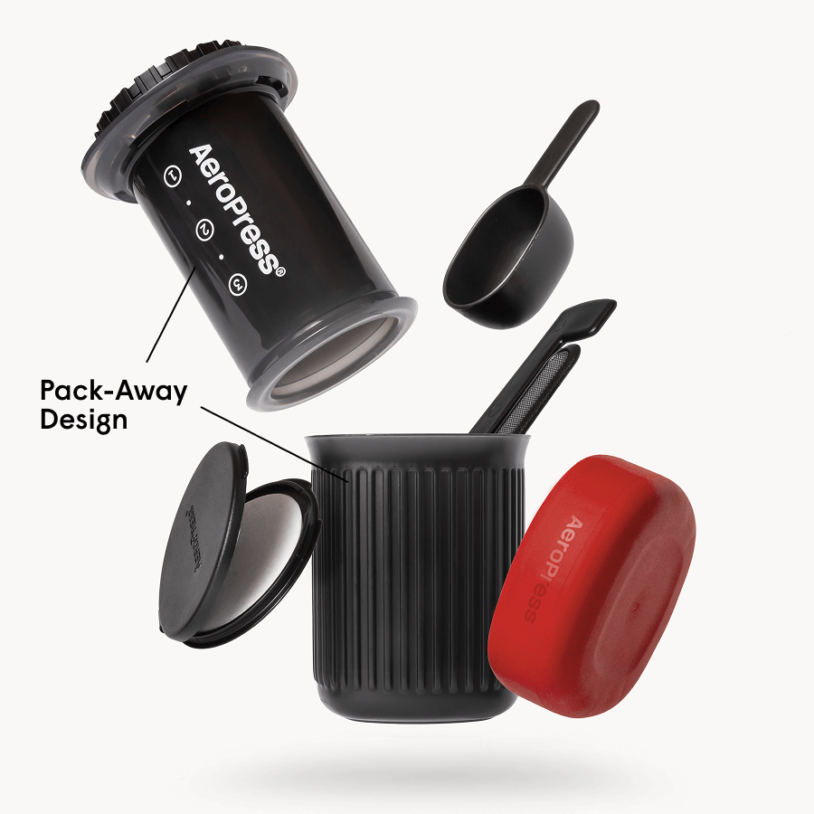 Go-style AeroPress coffee maker kit with travel mug and red silicone cap