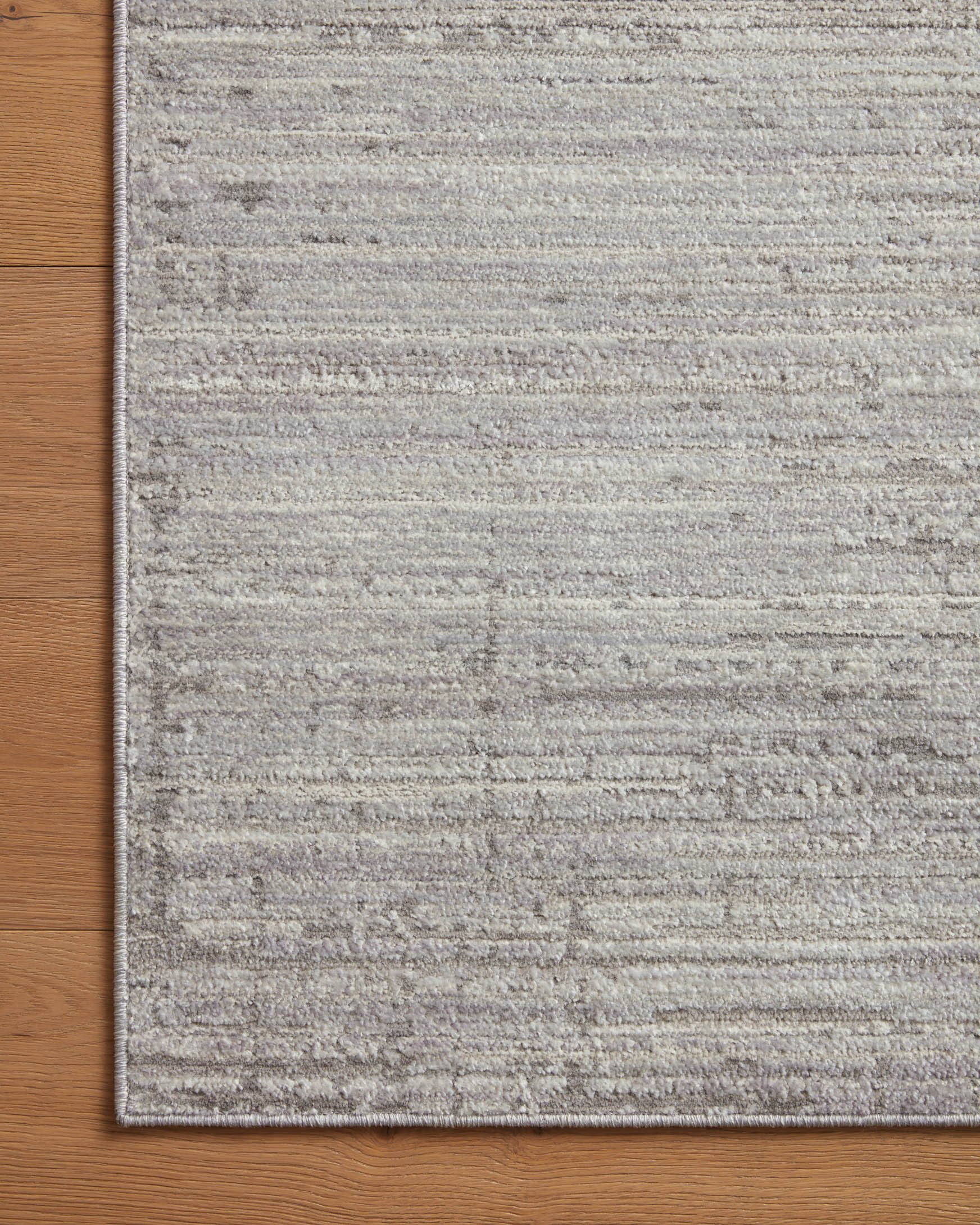 Silver and grey area rug with horizontal textured lines and bordered edge