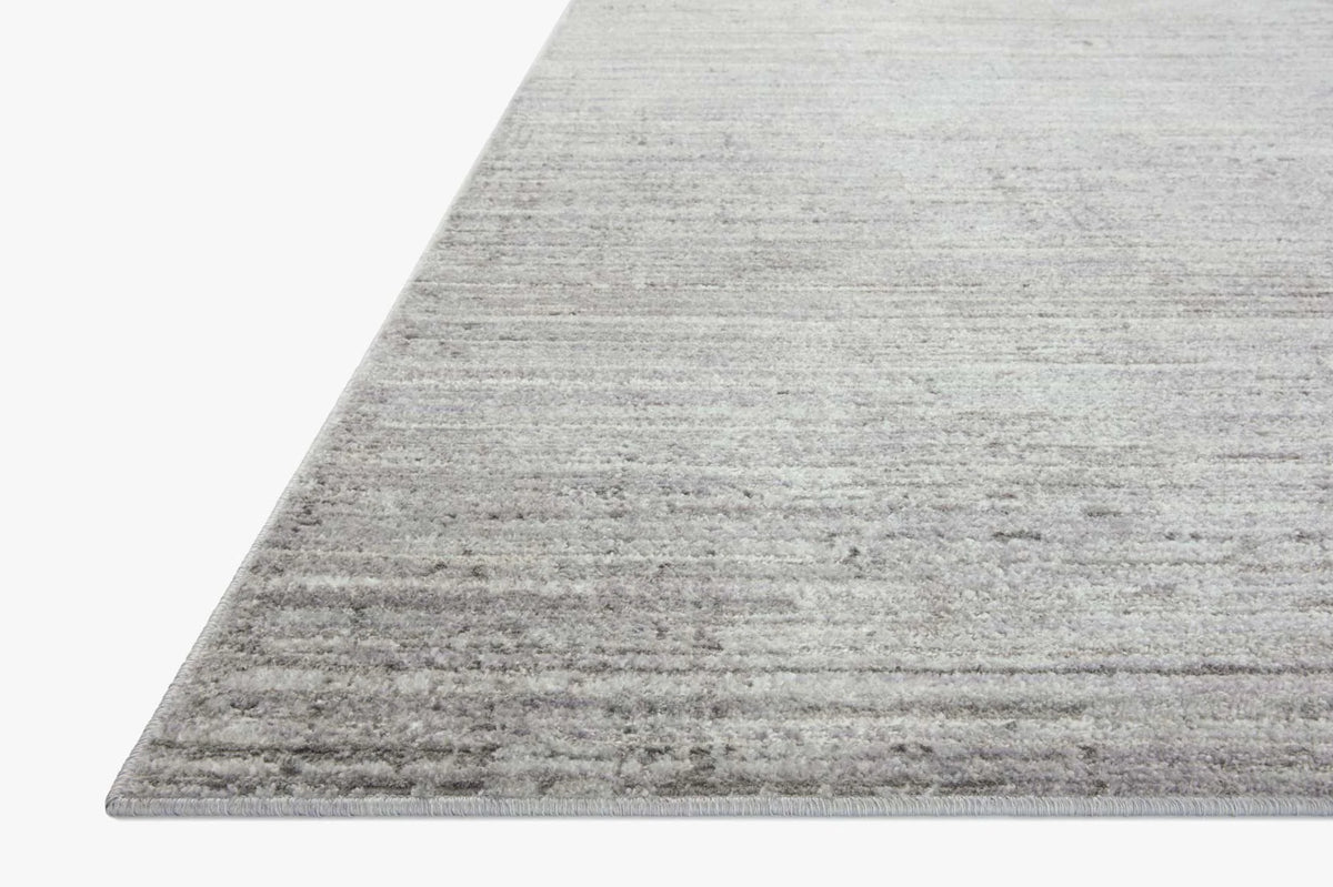 Silver and grey textured accent rug with subtle horizontal stripes, corner view
