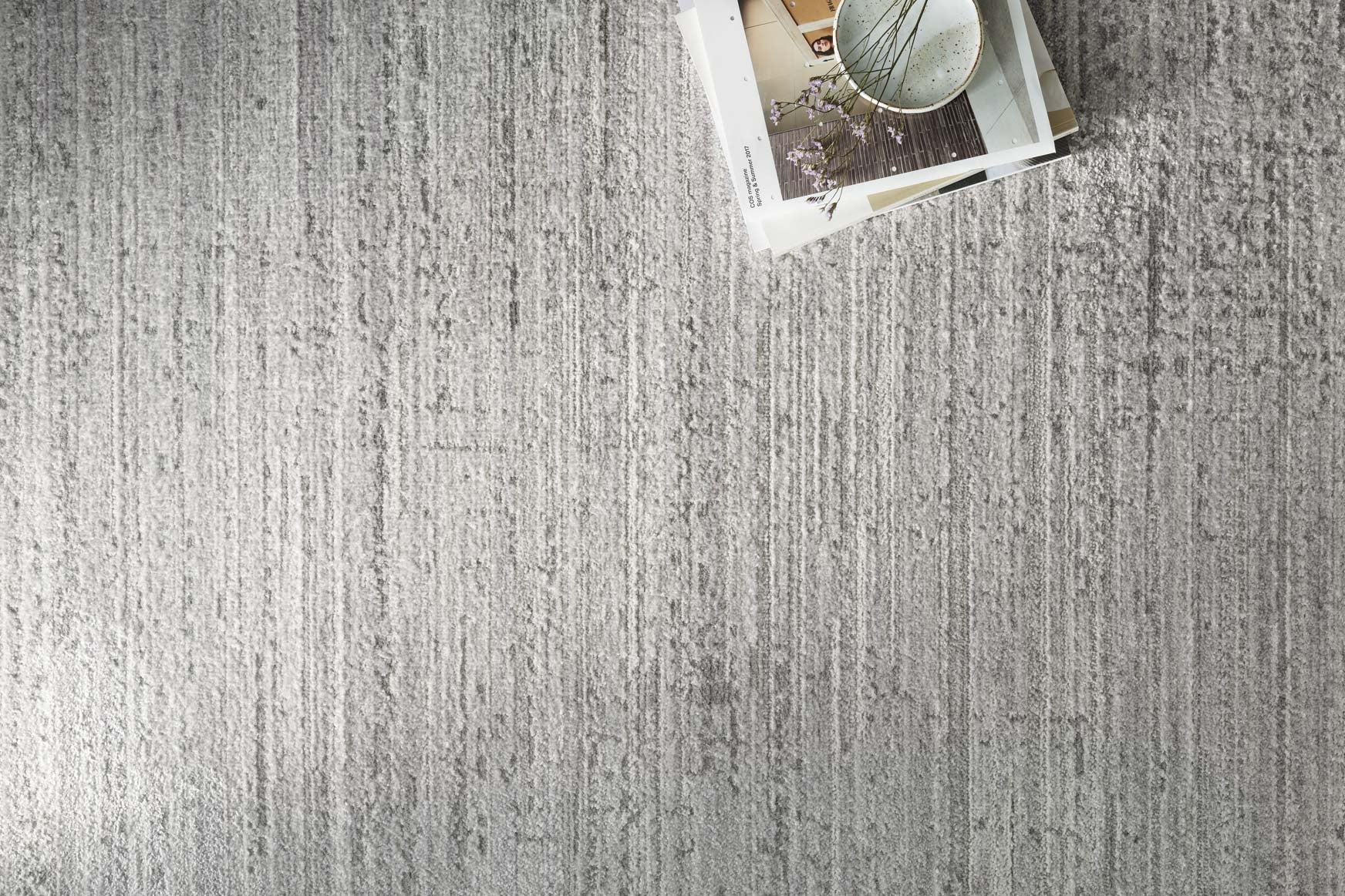 Silver and grey area rug with dense linear striations, flat low pile