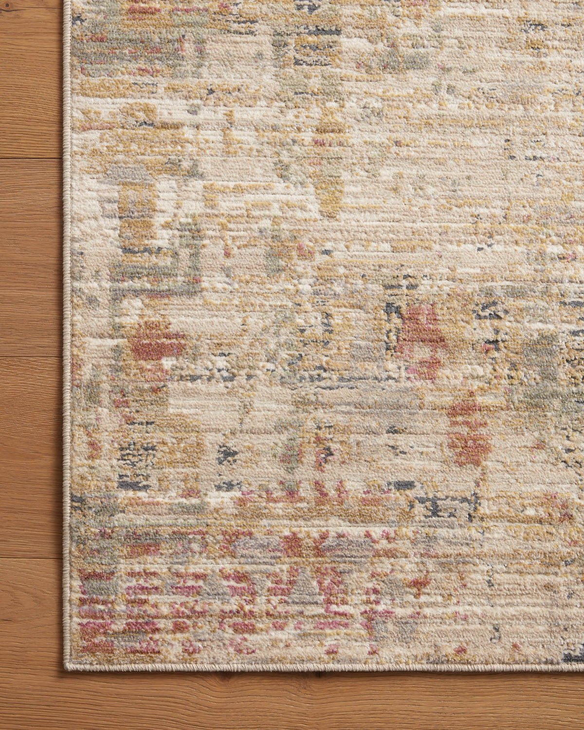 Sand area rug with abstract distressed blocks and speckled multicolor texture, border detail.