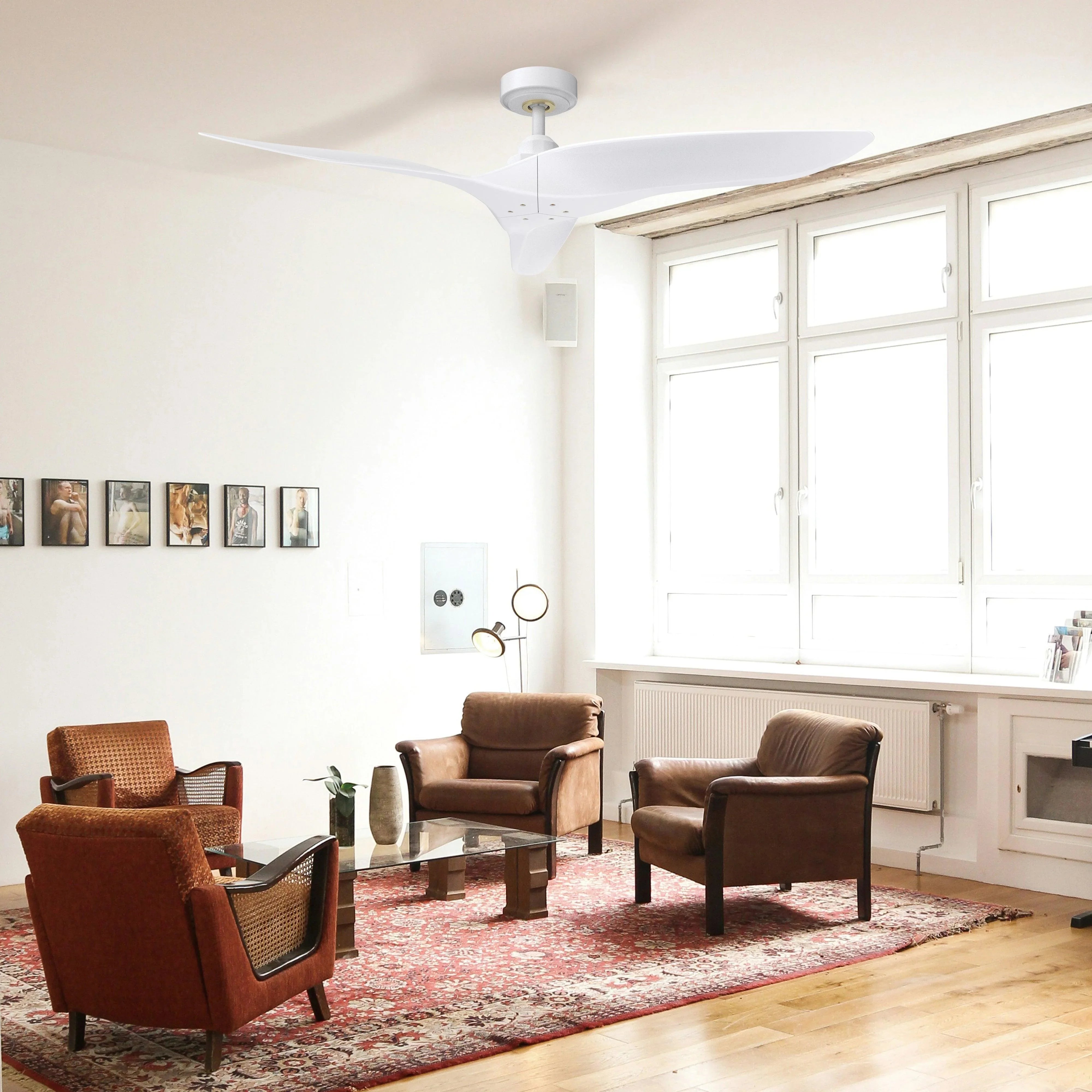 White ceiling fan with three blades and canopy mount in a bright living room