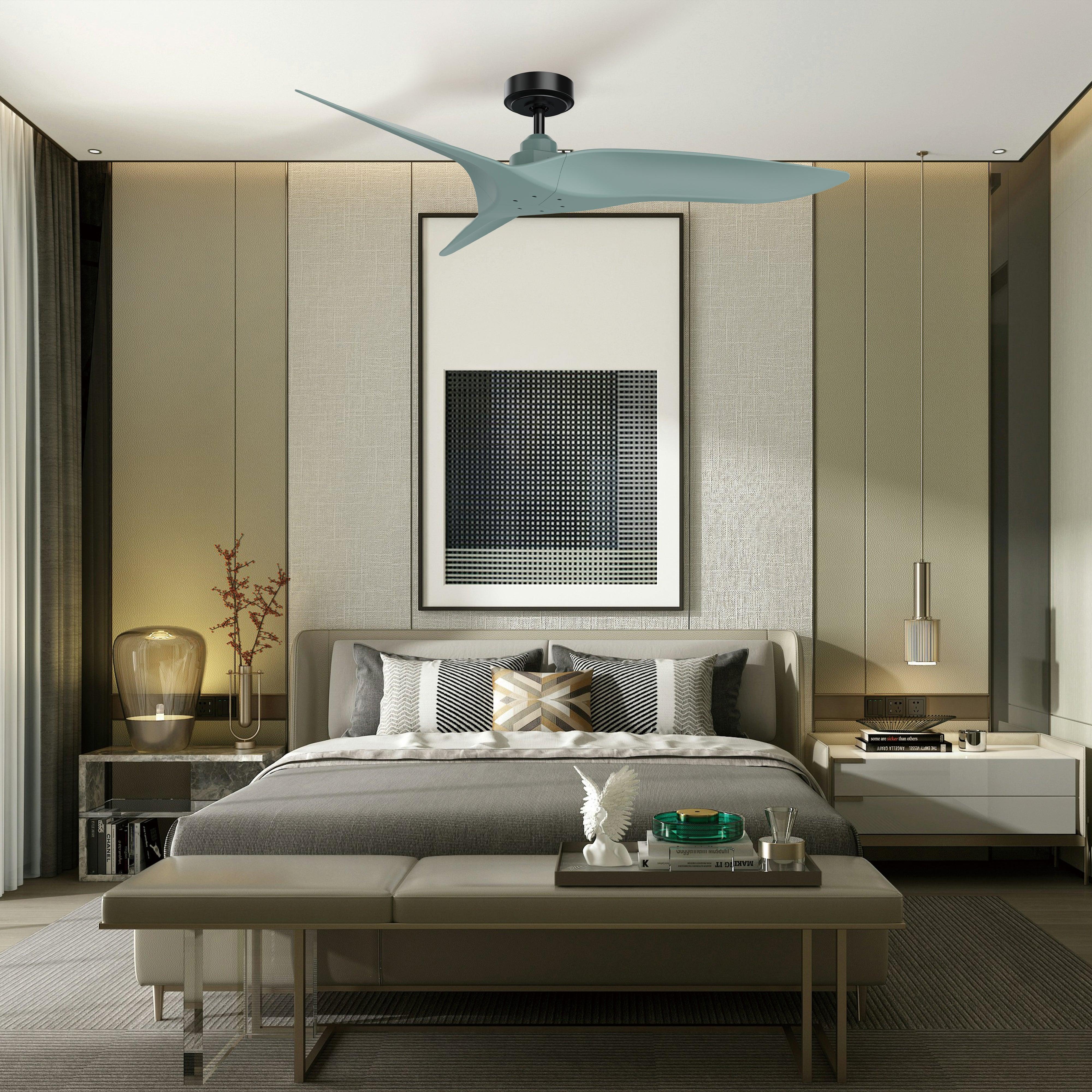 Light blue ceiling fan with three blades and dark motor housing above a bed