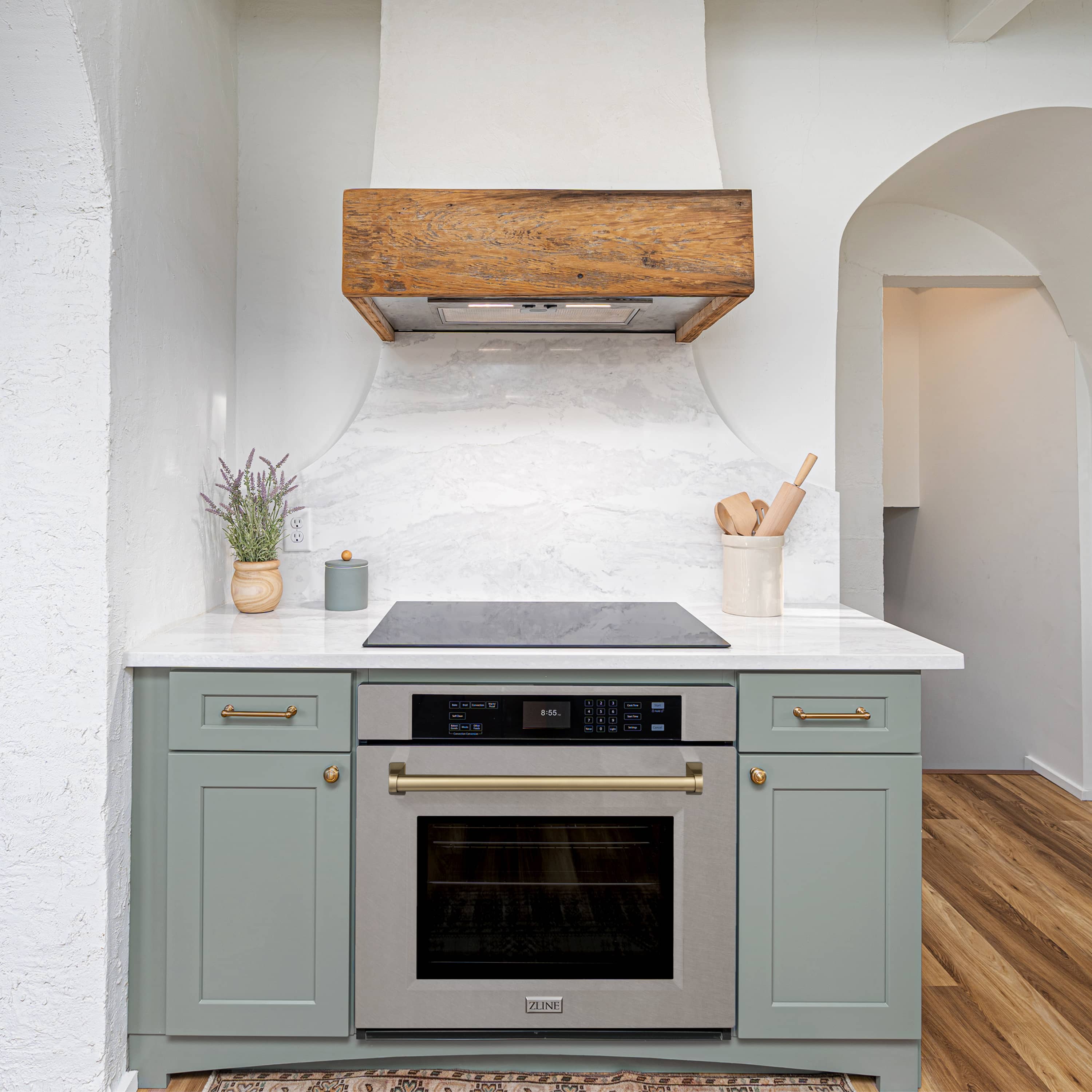 Built-in single wall oven with microwave overhang and champagne bronze trim in satin stainless
