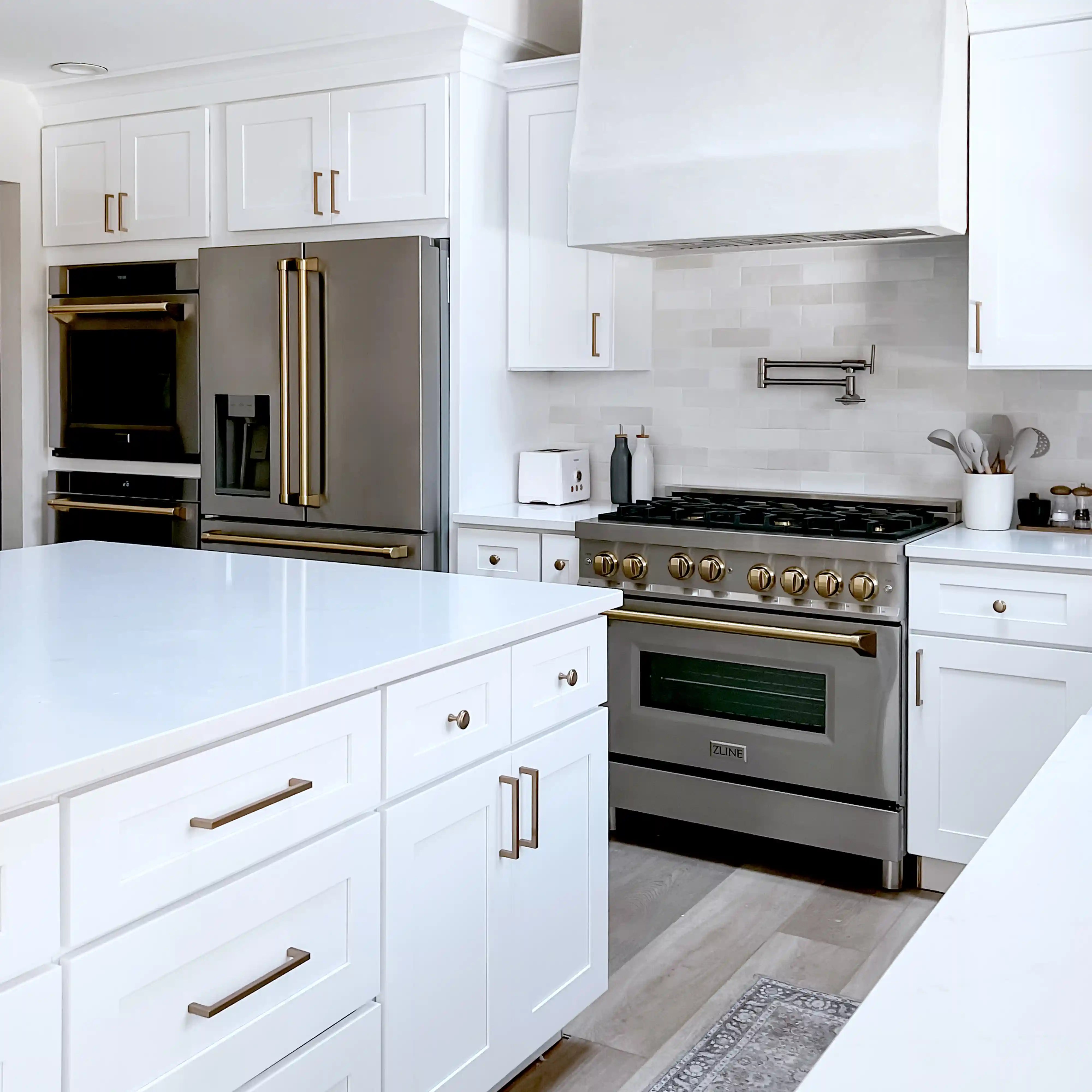 Stainless steel French door refrigerator with bronze handles and water/ice dispenser