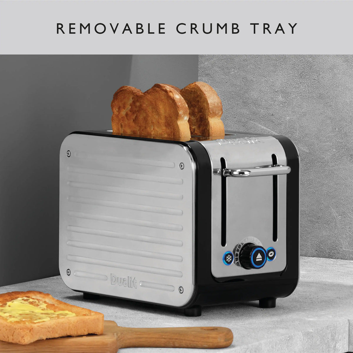 Dualit 2-slice toaster with visible crumb tray area and bread pieces inside
