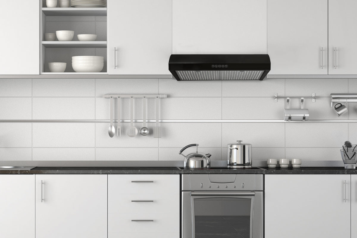 Black under-cabinet range hood installed under kitchen cabinets, with metal filter grilles
