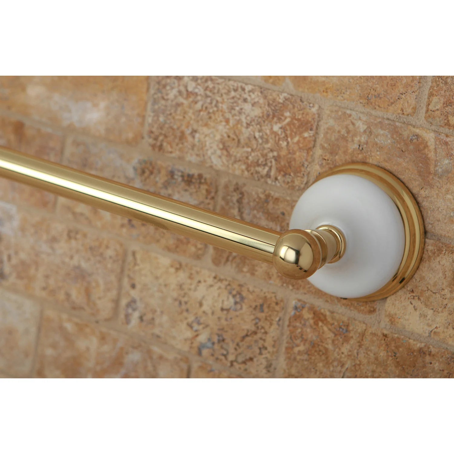 Close-up of polished brass single towel bar end cap and round wall mount