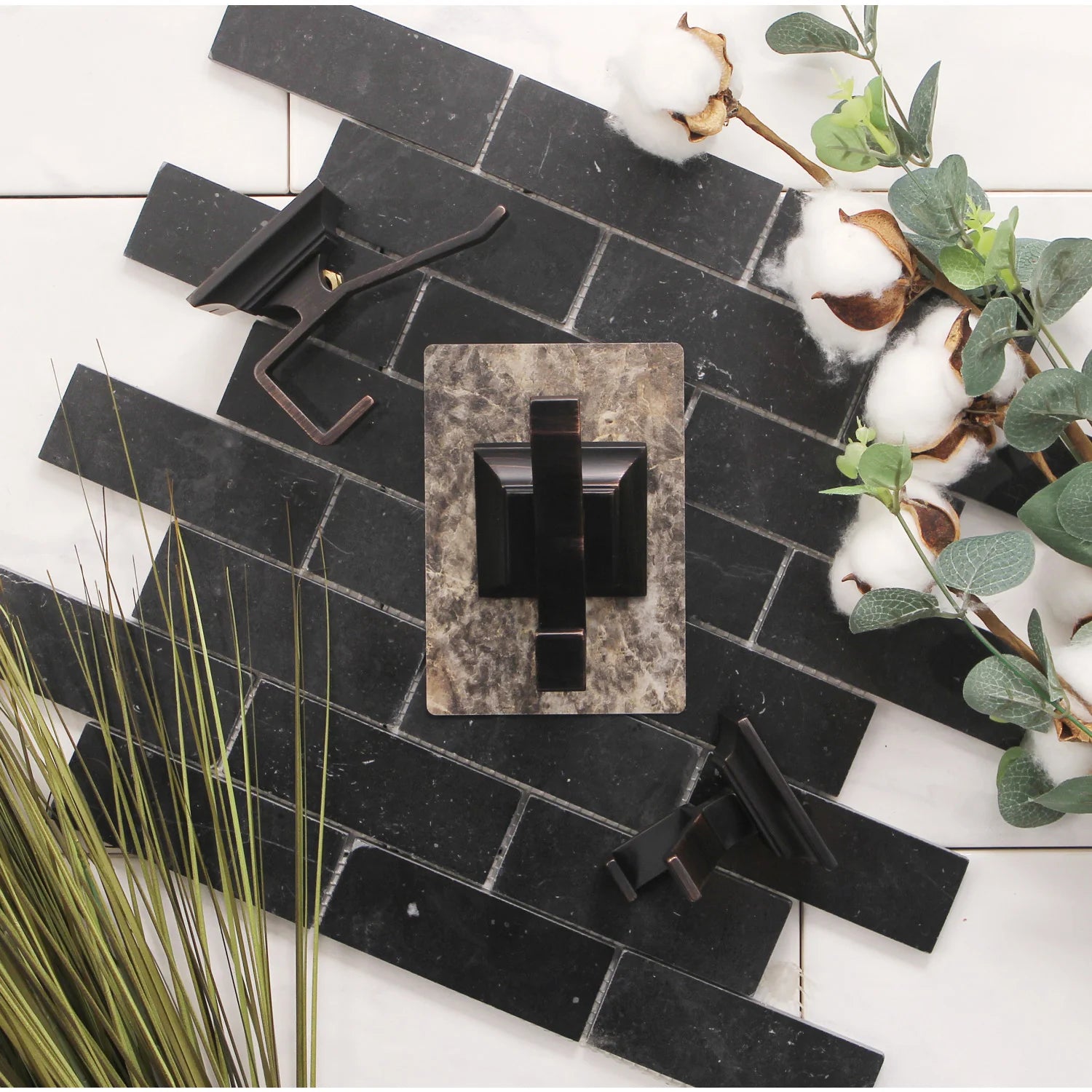 Single wall-mounted towel hook with square backplate in oil-rubbed bronze on tiled wall