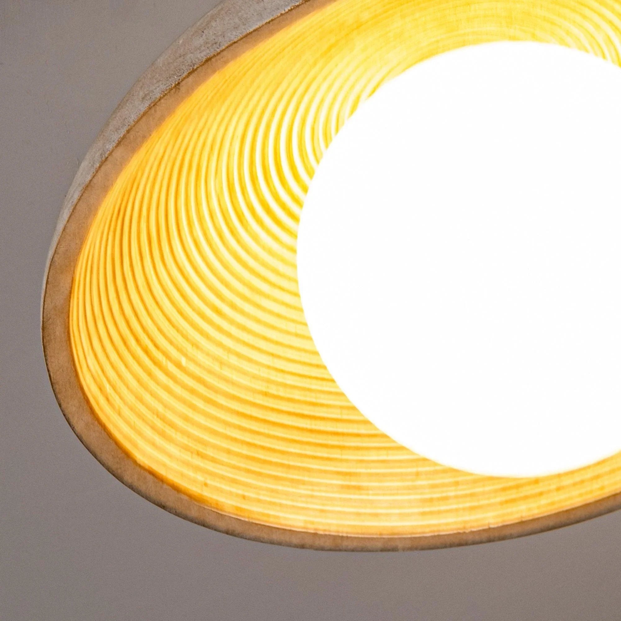 Farmhouse pendant light interior glow behind ribbed metal shade and frosted globe