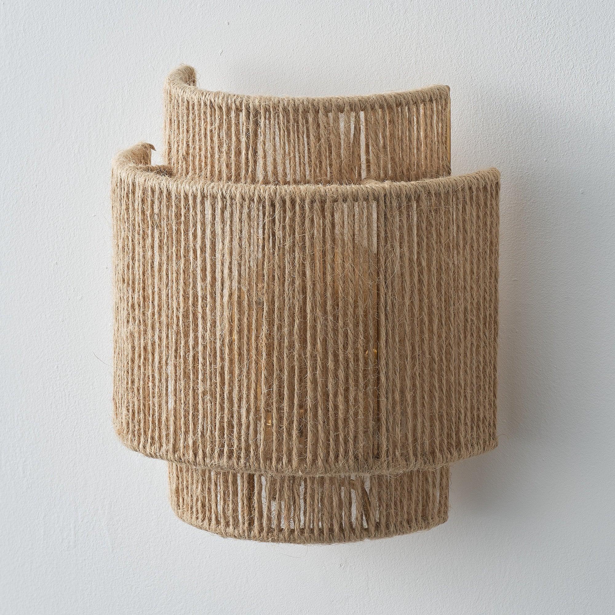 Brown rattan 1-light drum wall sconce with top and bottom cuffs