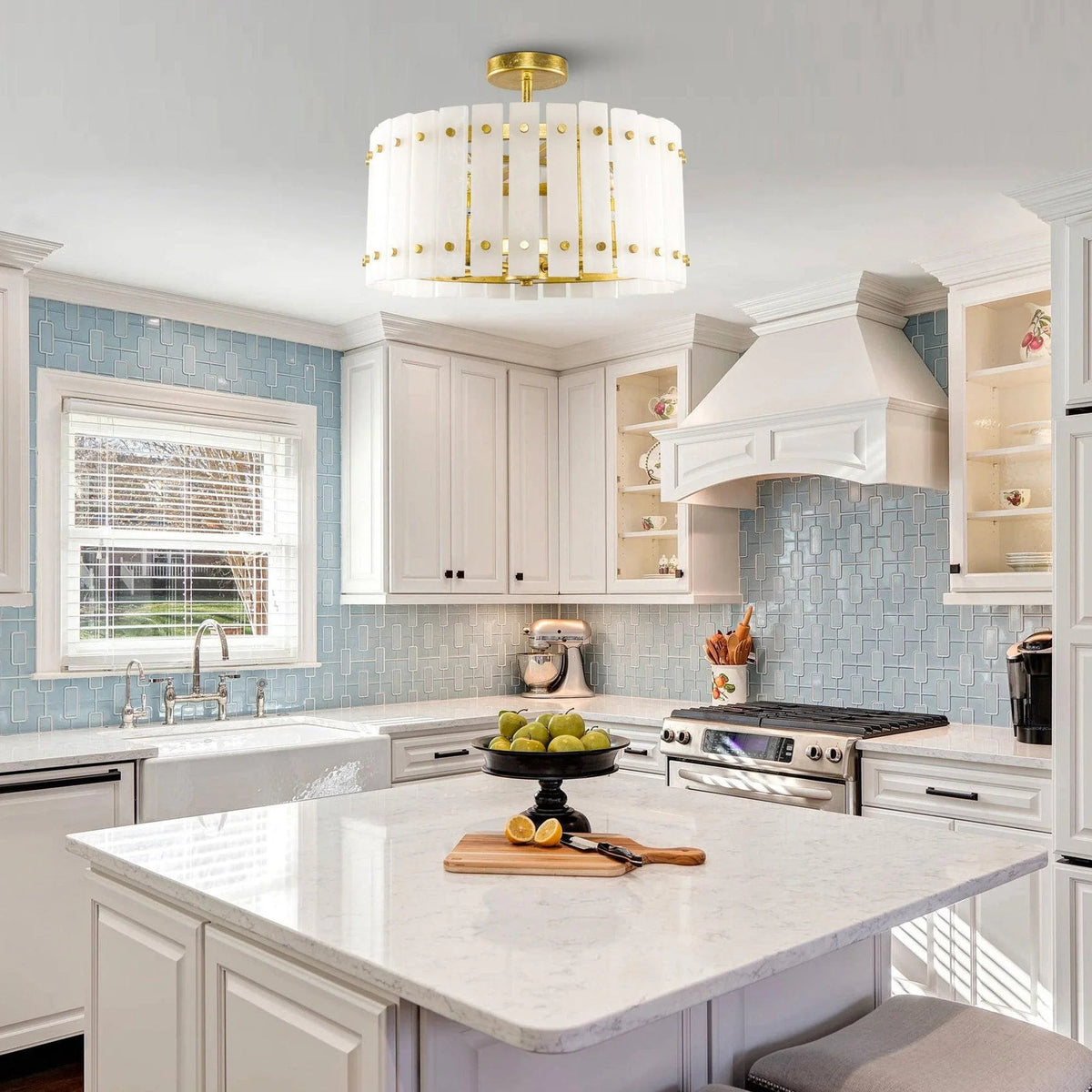 Golden 4-light drum semi flush ceiling light centered above a kitchen island